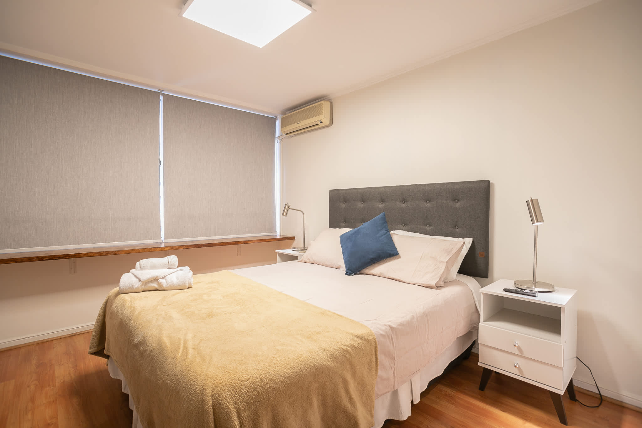 Relax in this cozy bedroom with a plush bed and modern decor, perfect for unwinding after a day exploring the city.