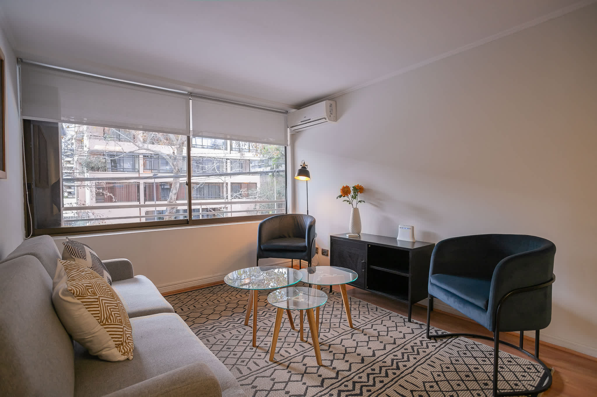 Cozy living area with stylish seating and natural light, perfect for relaxation in the heart of the city.