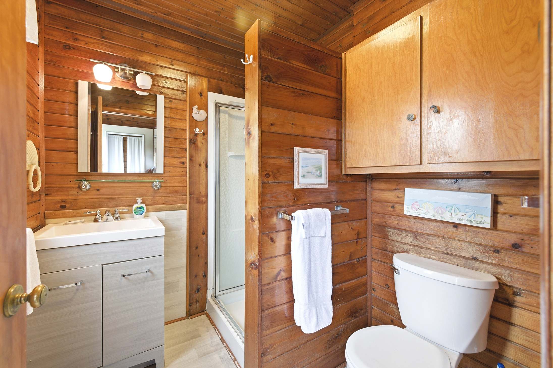 Main-level full bath provides everything needed between beach adventures.