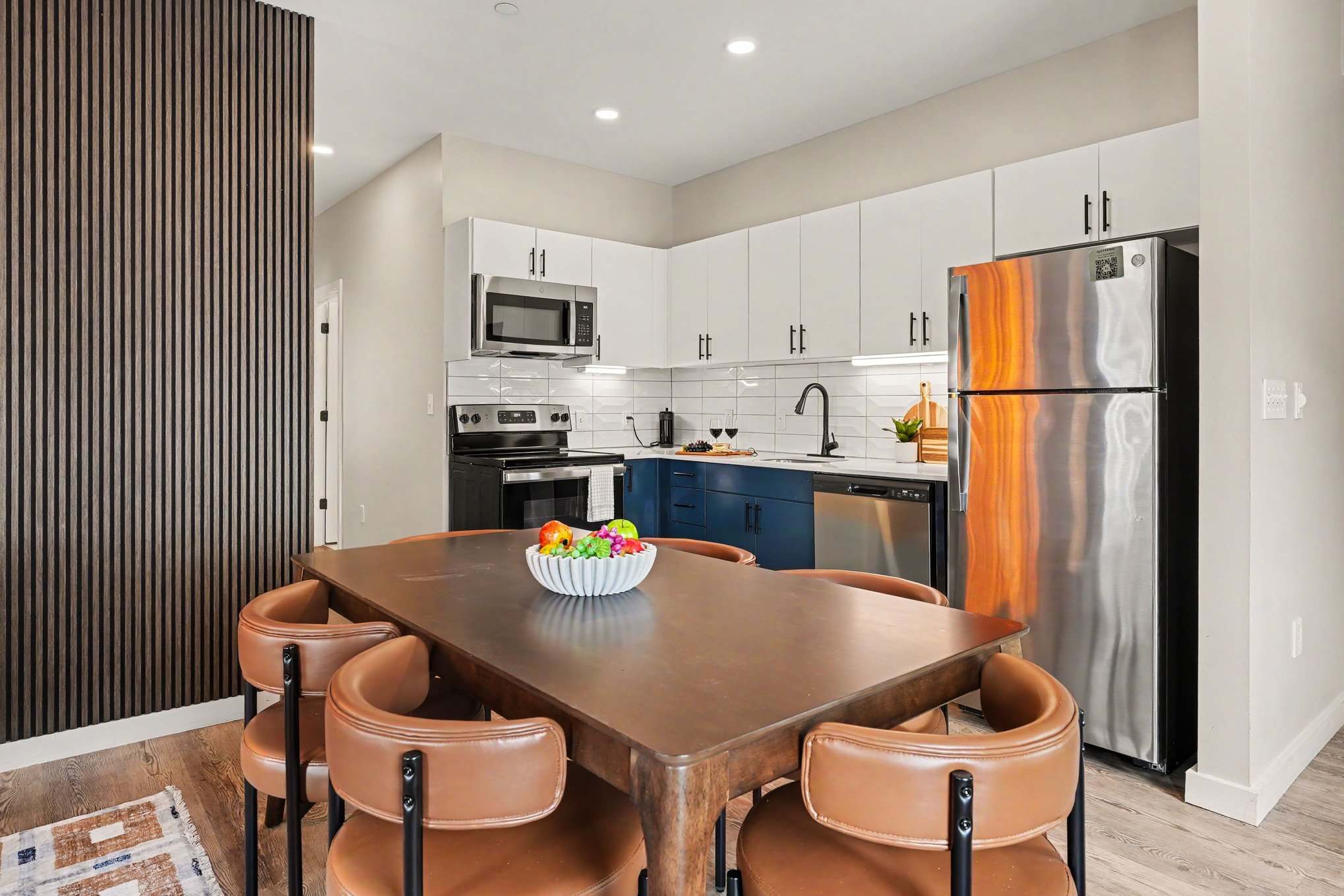This modern kitchen features sleek stainless steel appliances, dining area for 6, and all the essentials you need for a comfortable and convenient stay. Open concept to living area.