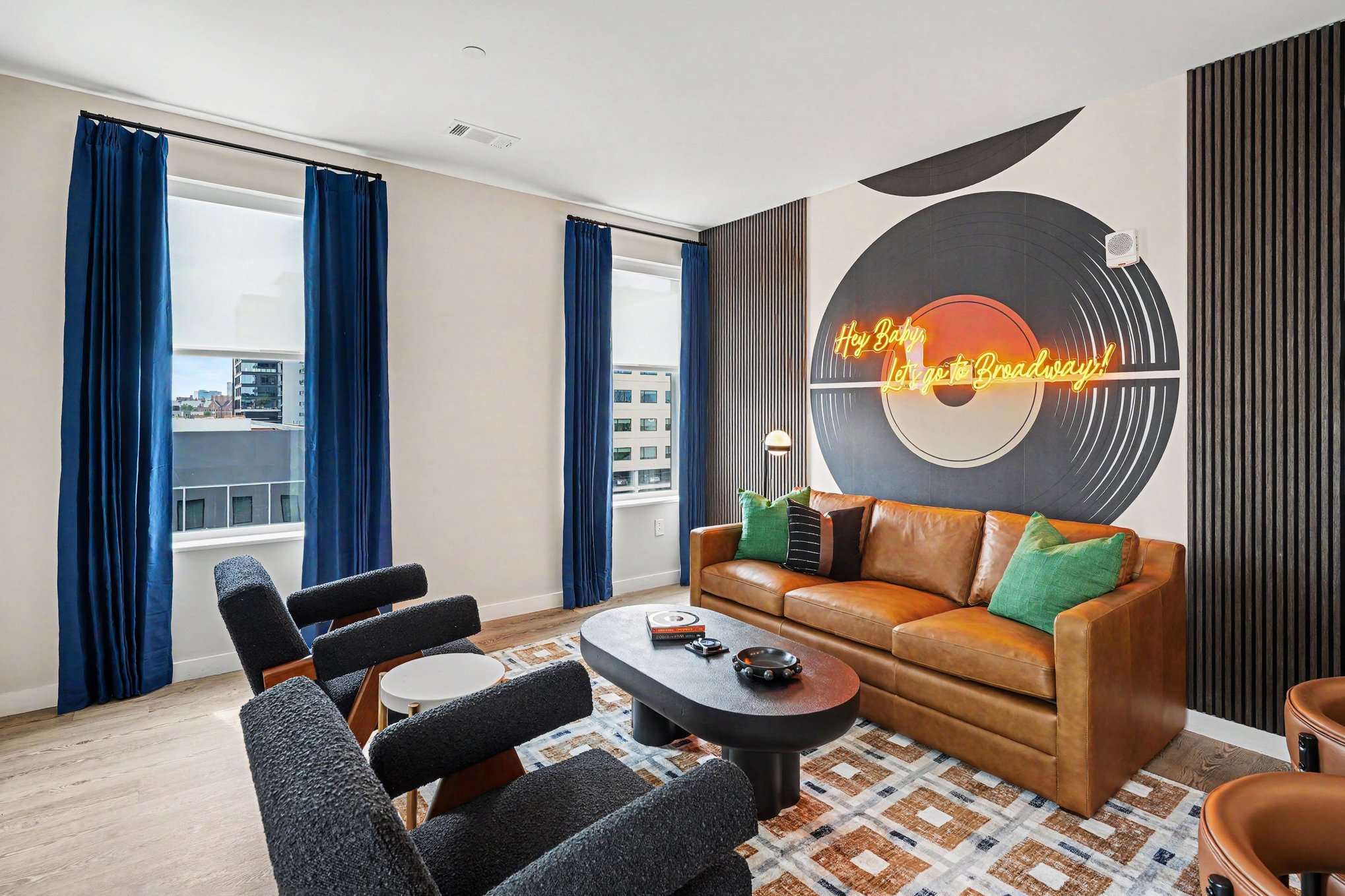 Bright and open living area featuring a smart TV and plush furnishings. Connects to the dining area and kitchen.