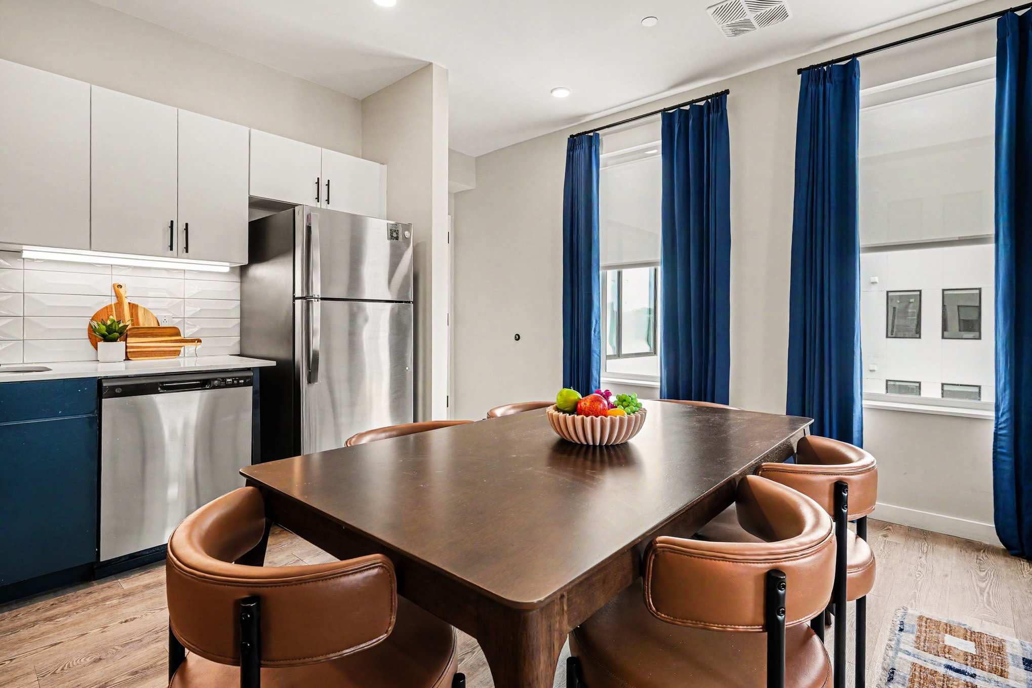 This modern kitchen features sleek stainless steel appliances, dining area for 6, and all the essentials you need for a comfortable and convenient stay. Open concept to living area.
