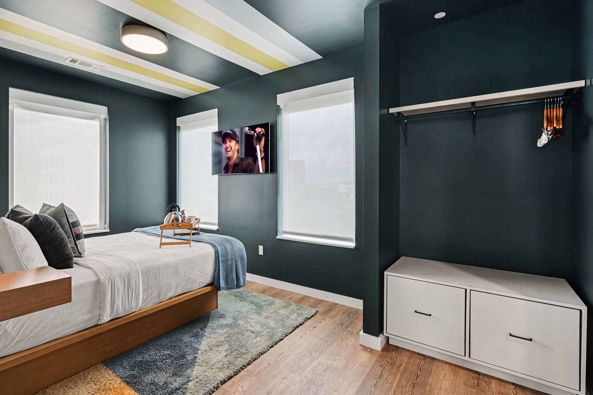 Primary Bedroom featuring a Queen bed, smart TV, closet space, and an en-suite bathroom.