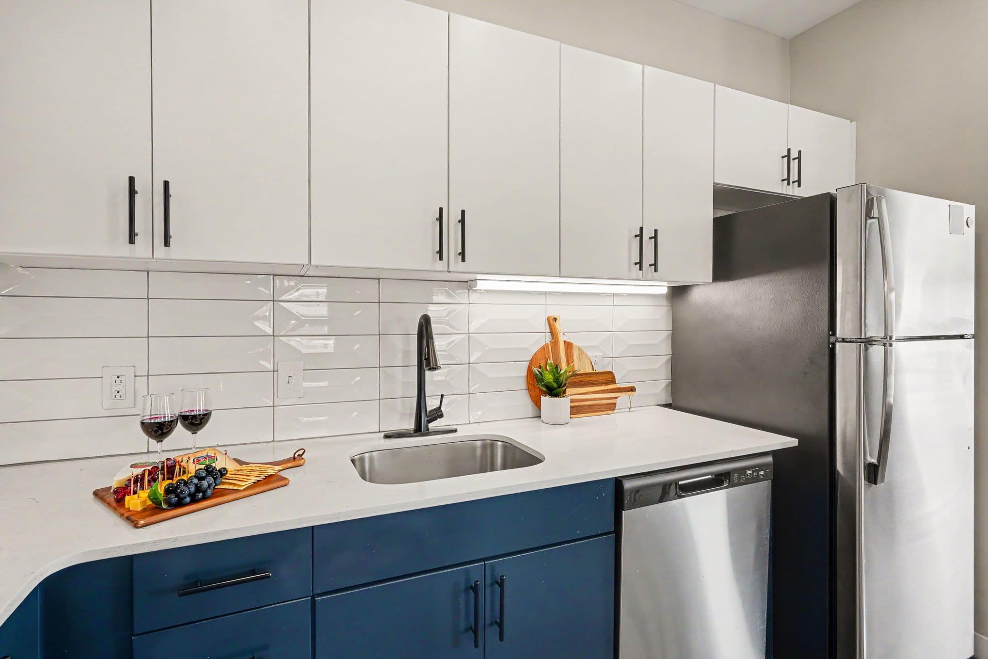 This modern kitchen features sleek stainless steel appliances, dining area for 6, and all the essentials you need for a comfortable and convenient stay. Open concept to living area.