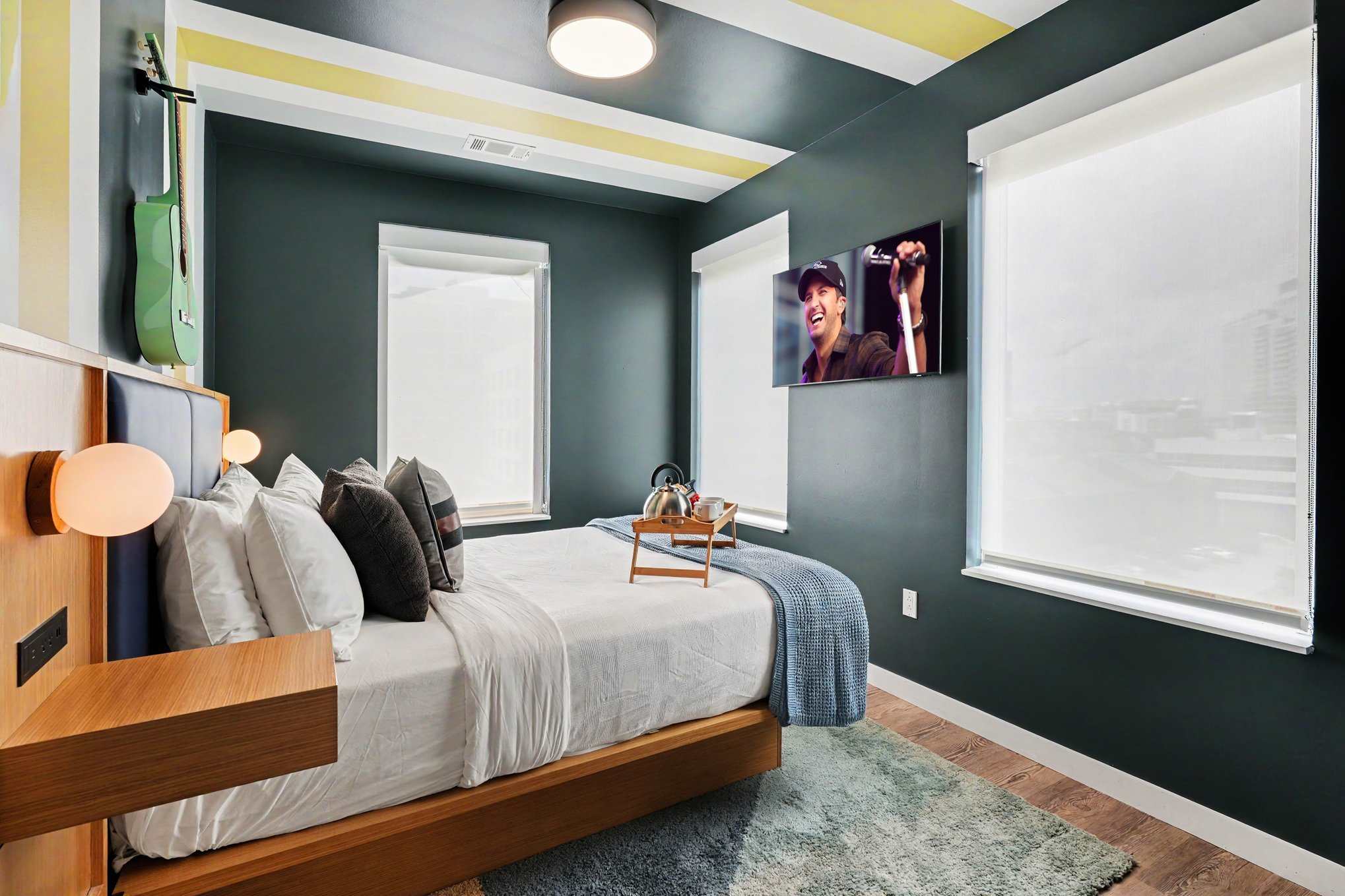 Primary Bedroom featuring a Queen bed, smart TV, closet space, and an en-suite bathroom.