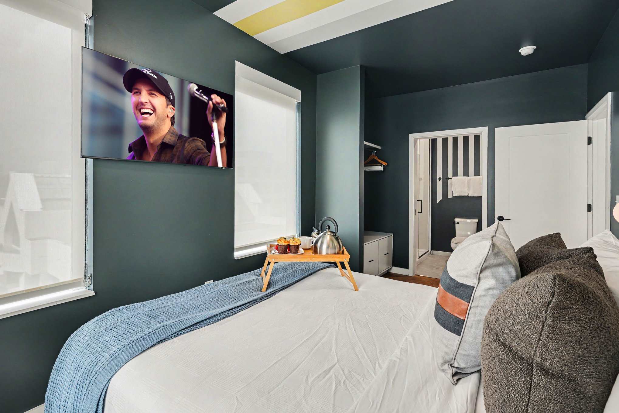Primary Bedroom featuring a Queen bed, smart TV, closet space, and an en-suite bathroom.
