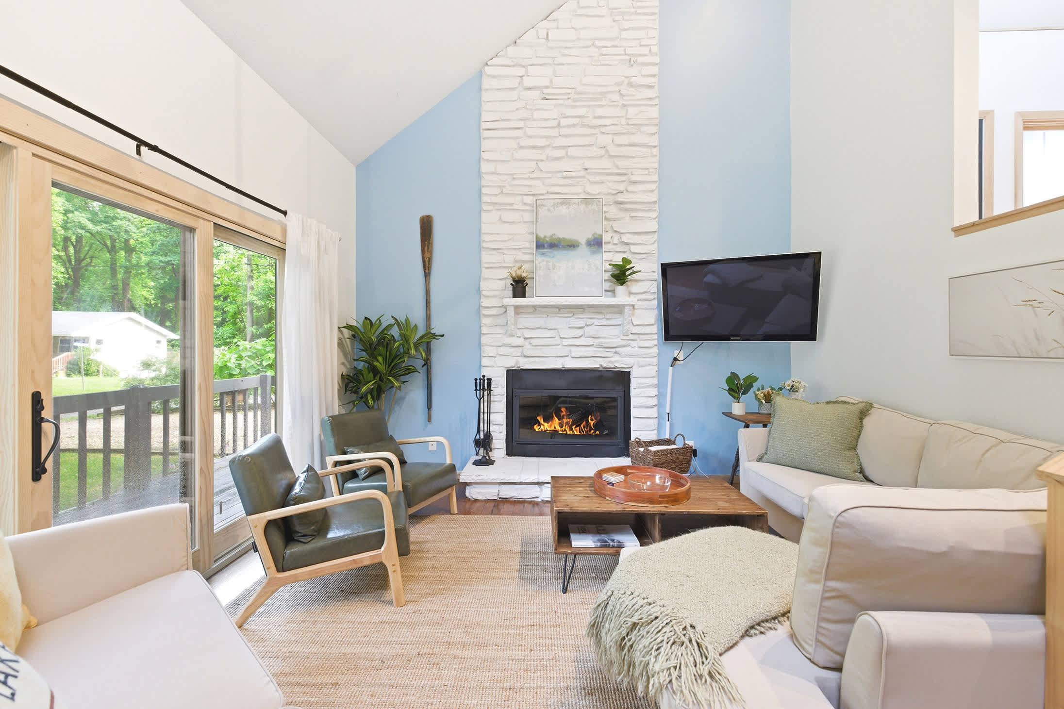 Warm light, soft seating, and fireside charm await at La Maison du Lac.