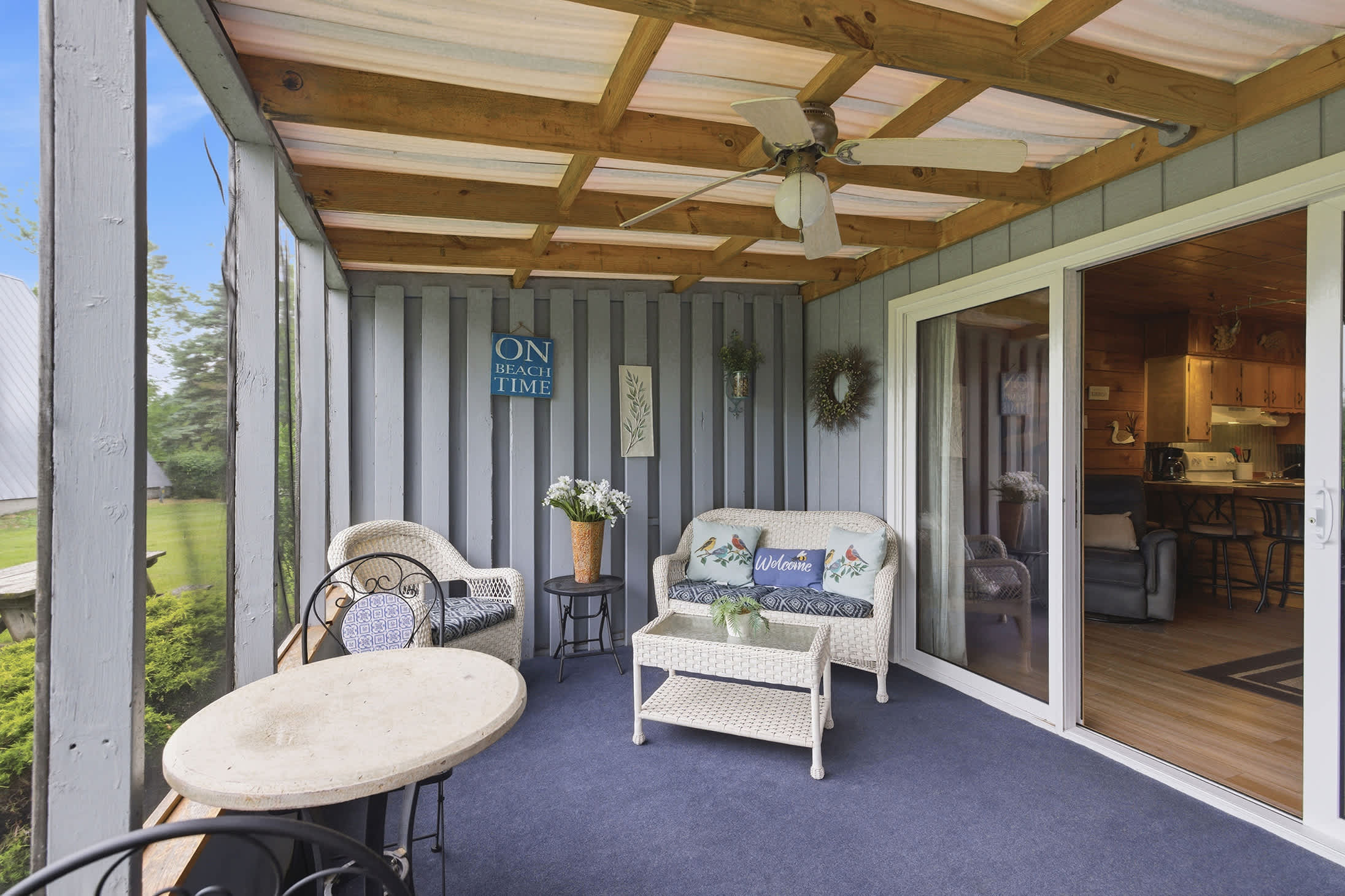 Screened porch adds a comfortable outdoor space beside the living area.