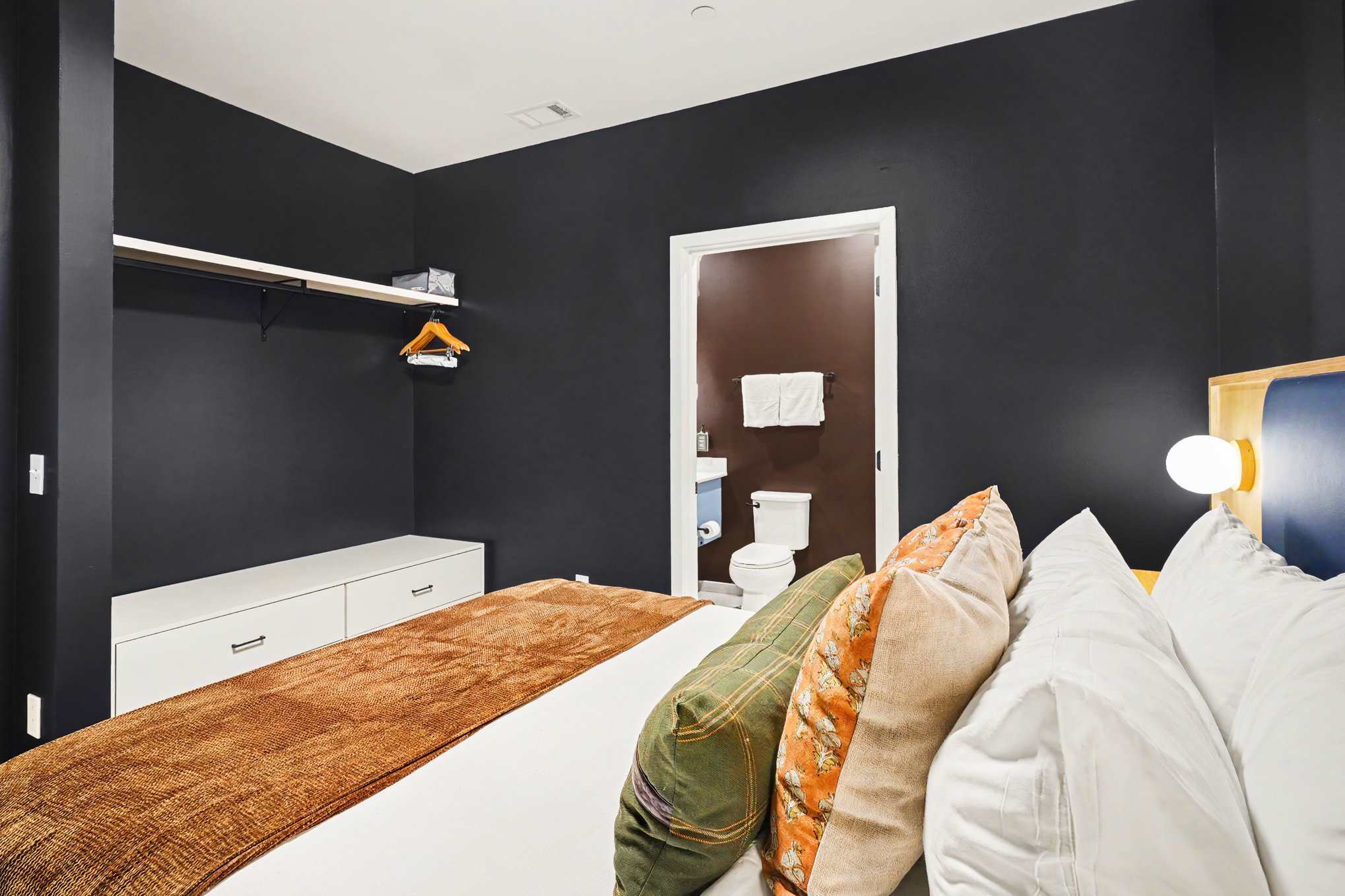 Primary Bedroom featuring a Queen bed, smart TV, closet space, and an en-suite bathroom.
