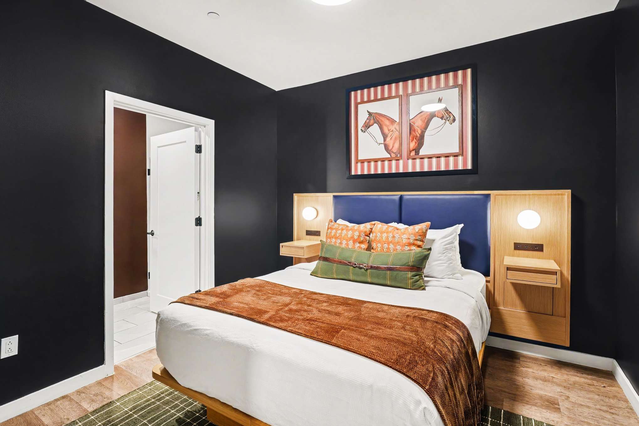 Primary Bedroom featuring a Queen bed, smart TV, closet space, and an en-suite bathroom.