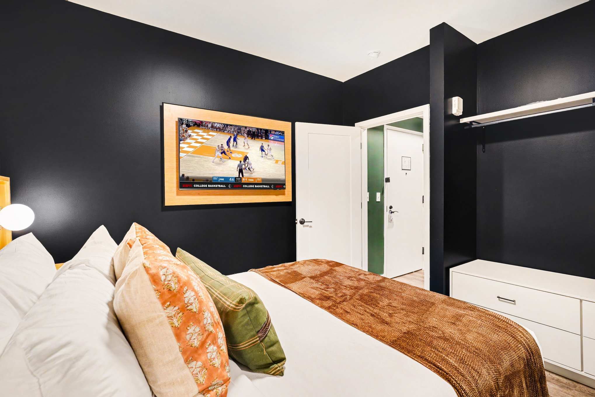 Primary Bedroom featuring a Queen bed, smart TV, closet space, and an en-suite bathroom.