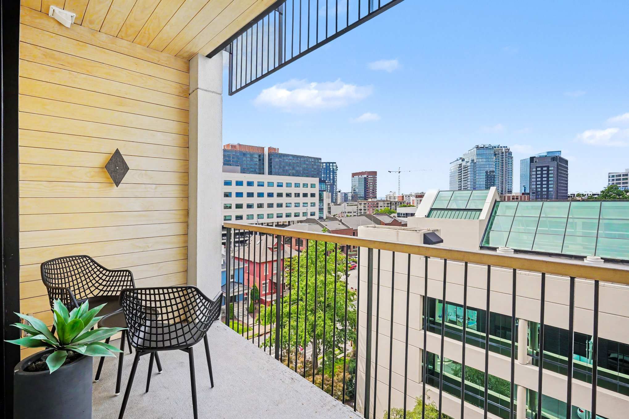 Private balcony with outdoor seating and views of downtown.