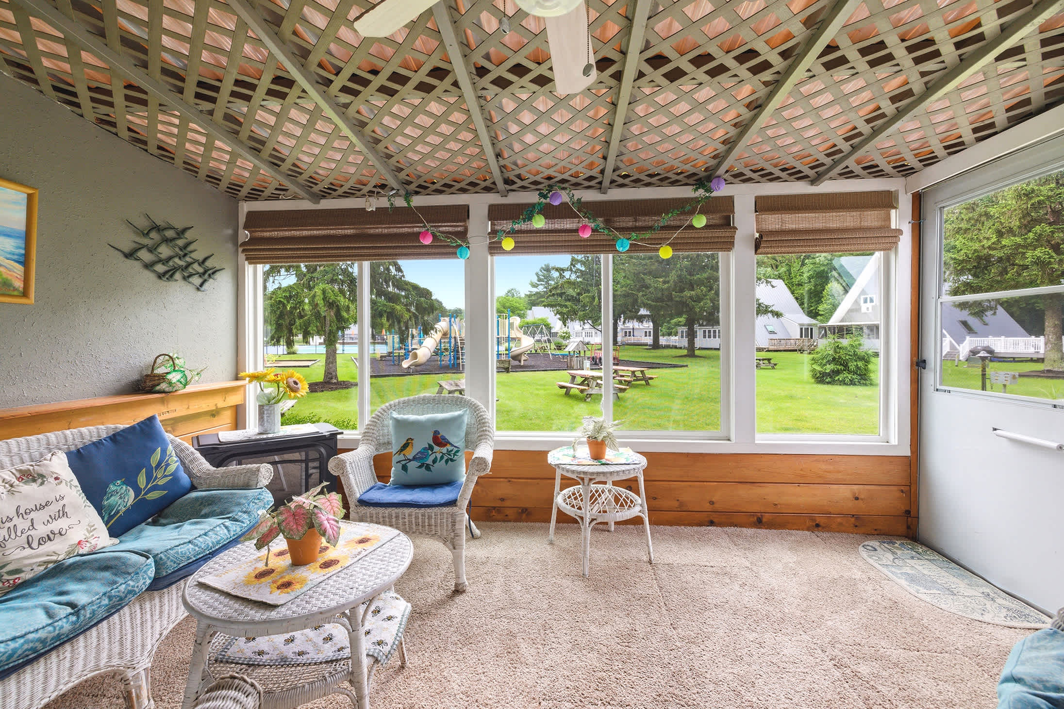 Screened porch offers front row views of the playground and green space.