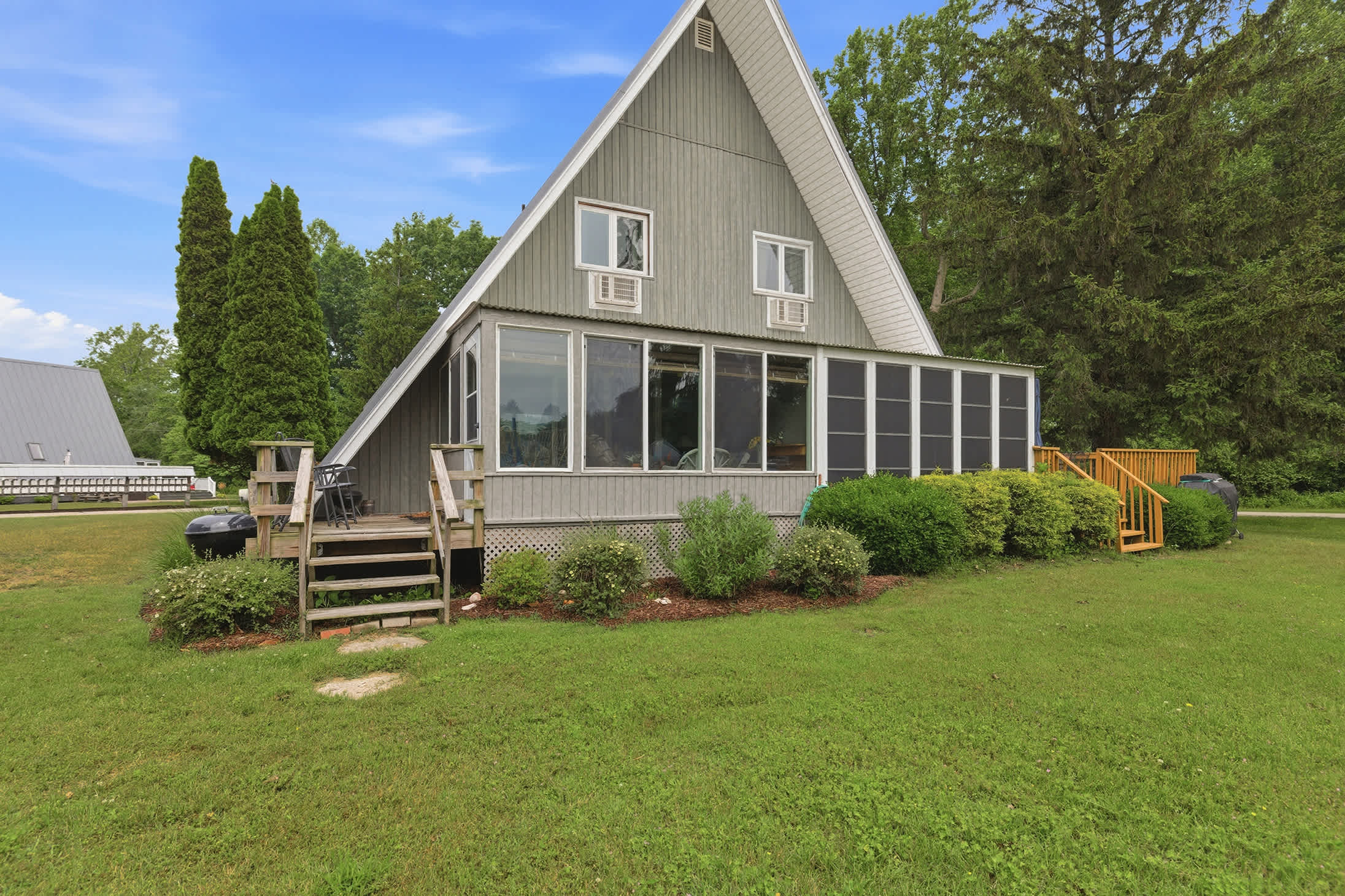 Chalet #74 offers a screened porch, outdoor decks, and easy access to resort amenities for a family-friendly Lake Michigan getaway.