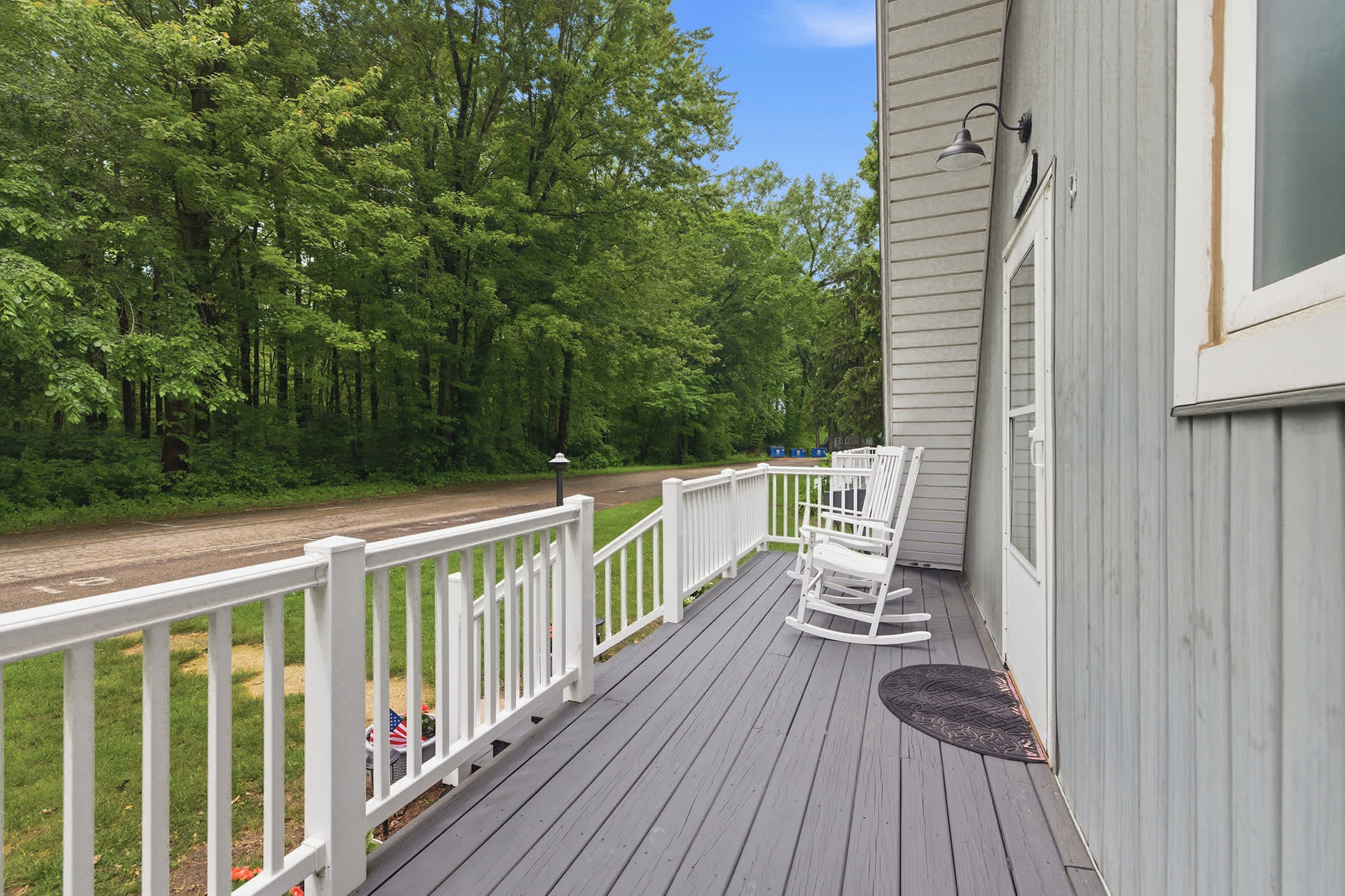 The front porch offers outdoor seating with a quiet view of the resort grounds.