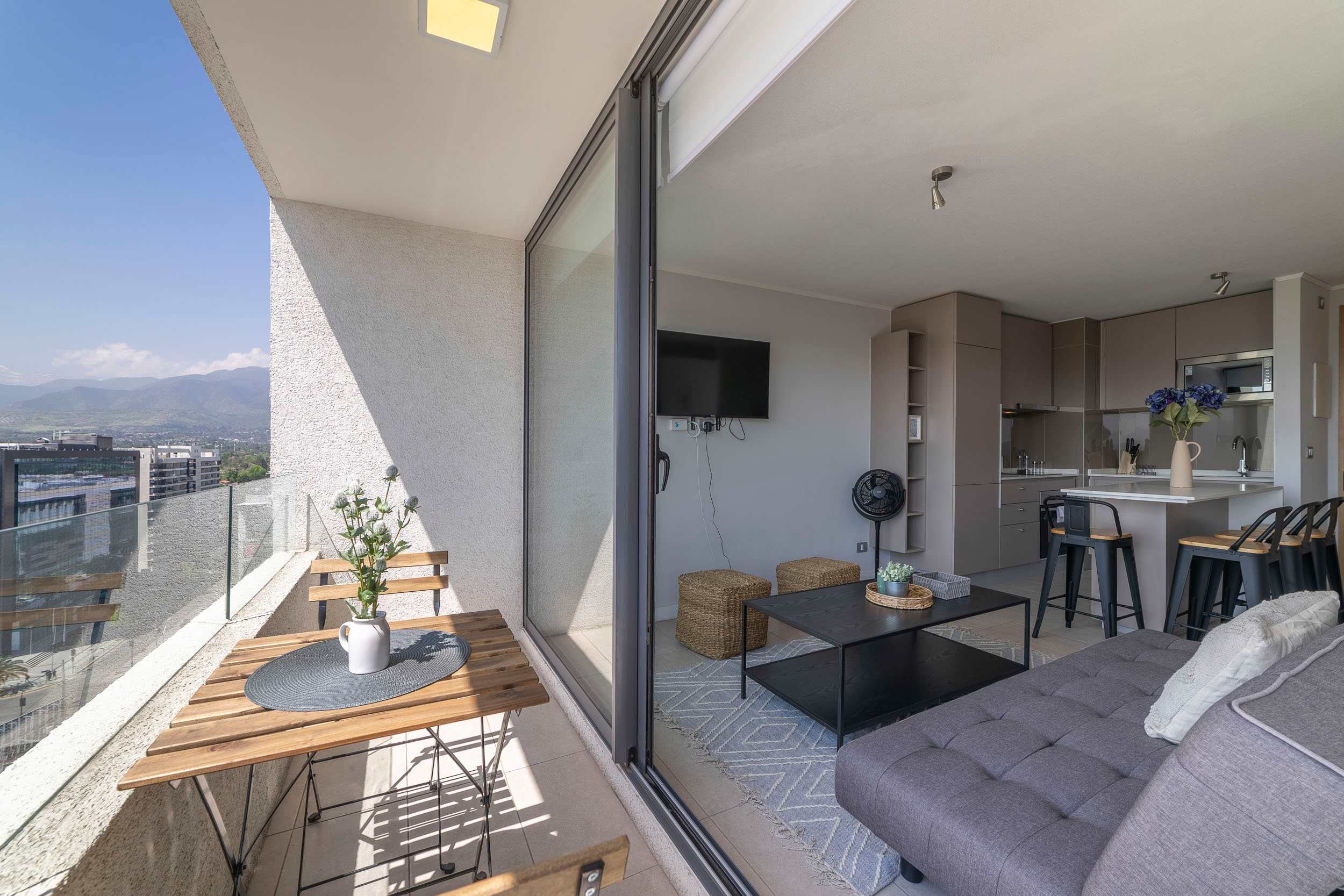 Enjoy stunning city and mountain views from this modern studio with a cozy living area and private balcony.