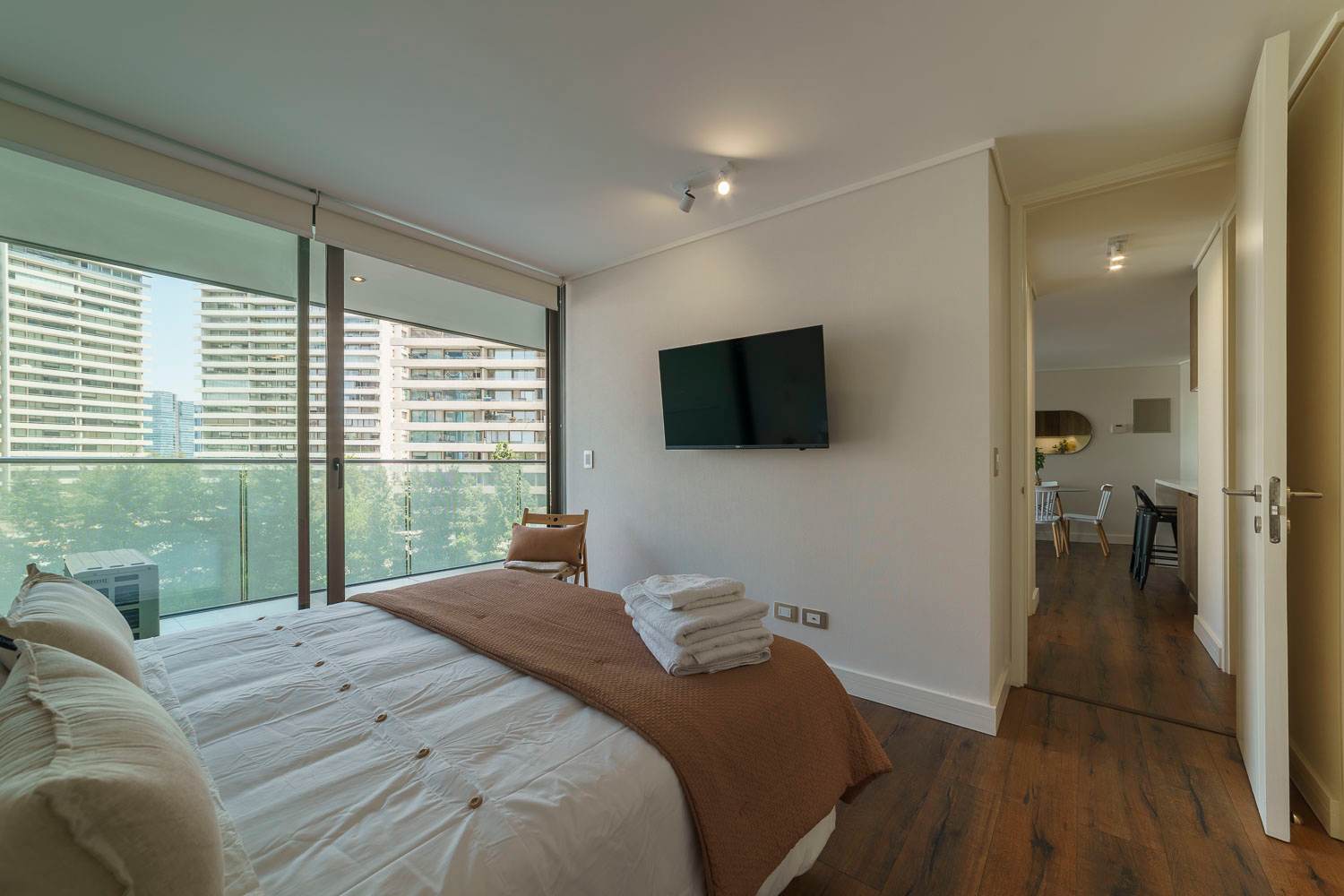 Relax in this cozy bedroom with a stunning city view and modern amenities.