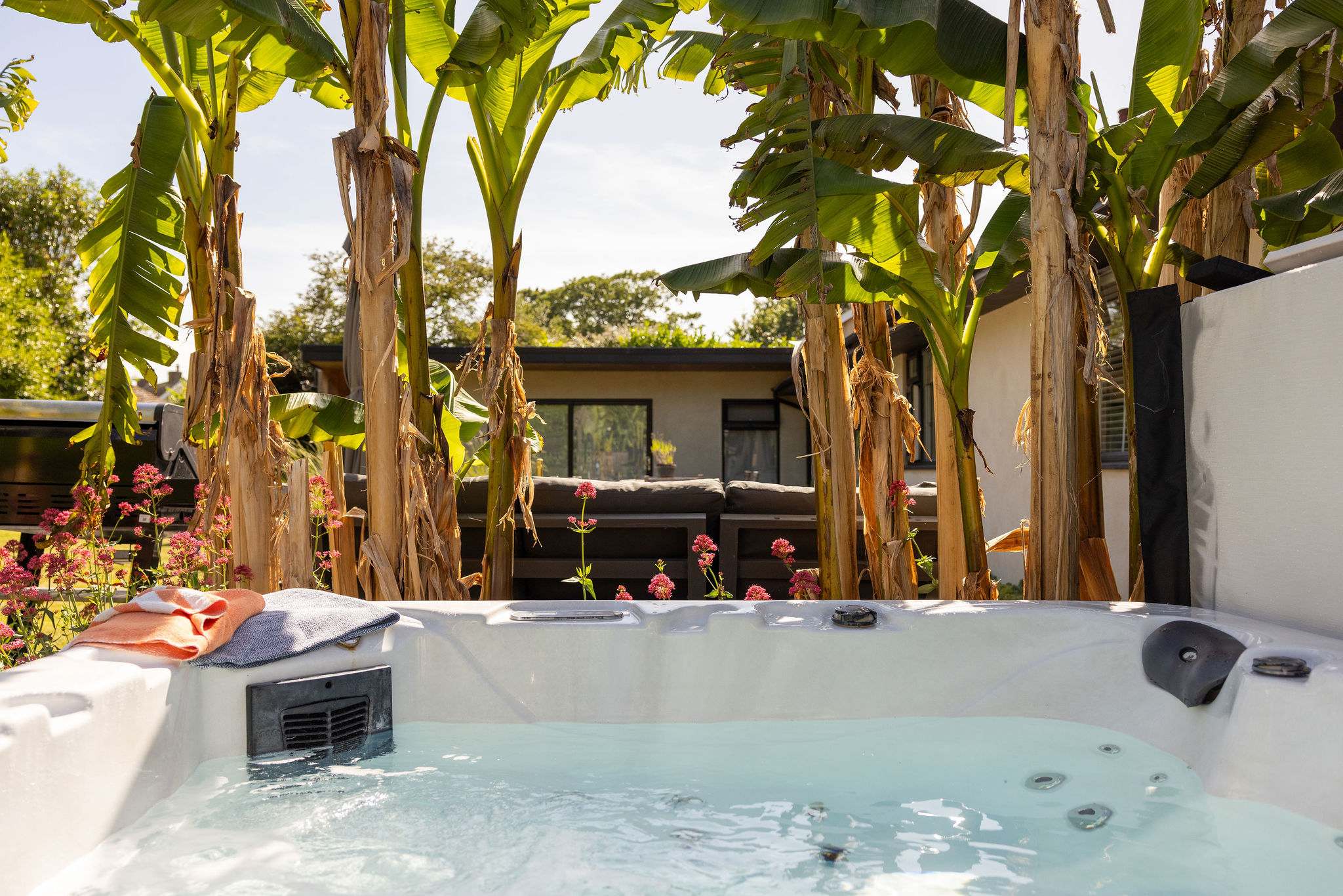 A peaceful hot tub spot framed by tropical-style planting