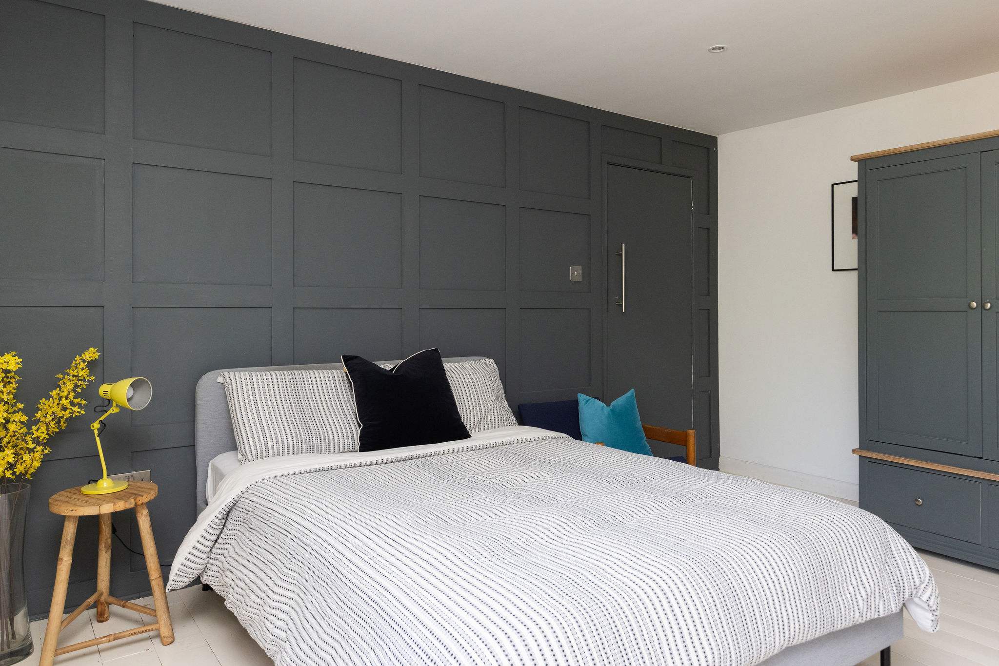 A stylish double bedroom with bold feature panelling