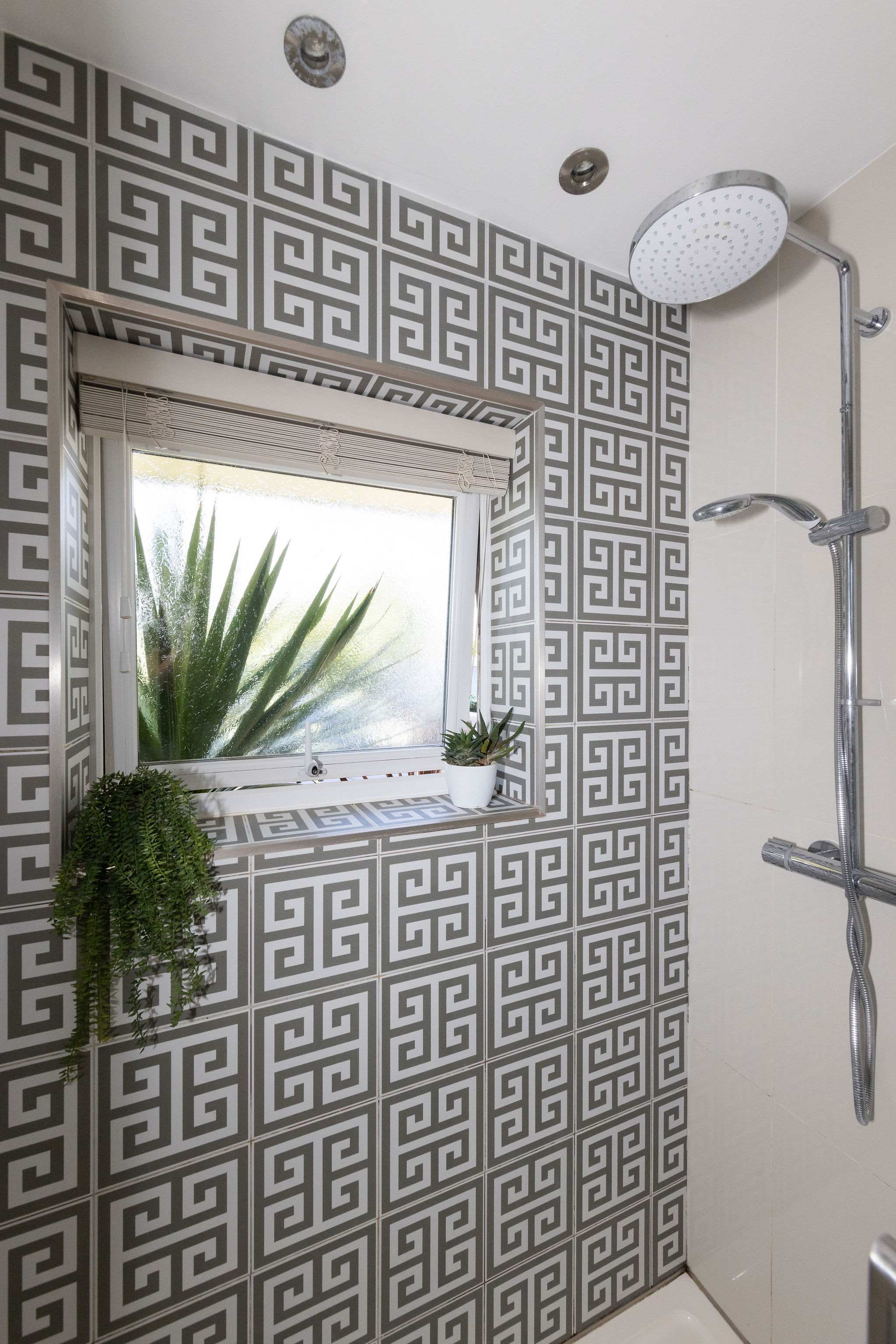 Patterned tiles add character to the walk-in shower