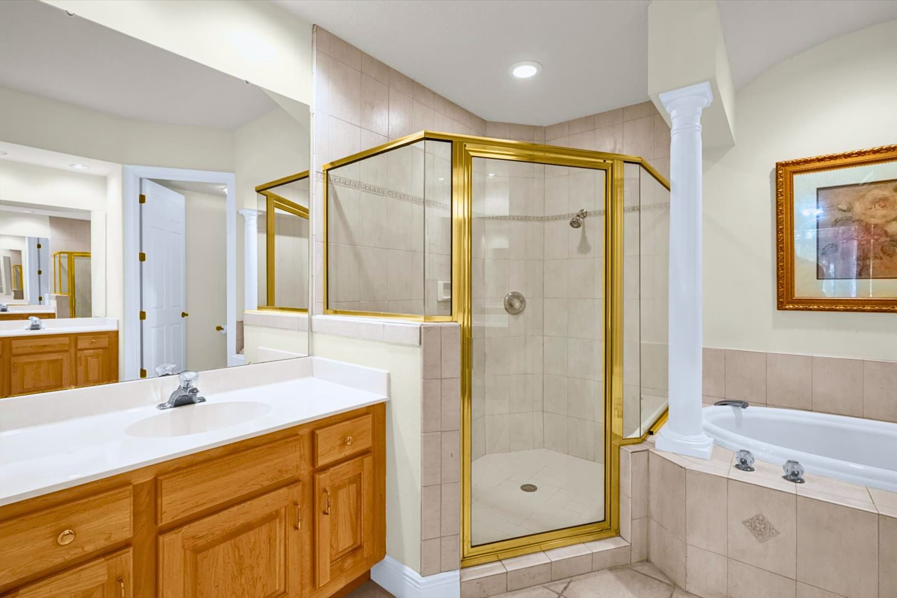 Bathroom with sink, mirror, walk in shower, and bathtub, supports easy daily routines