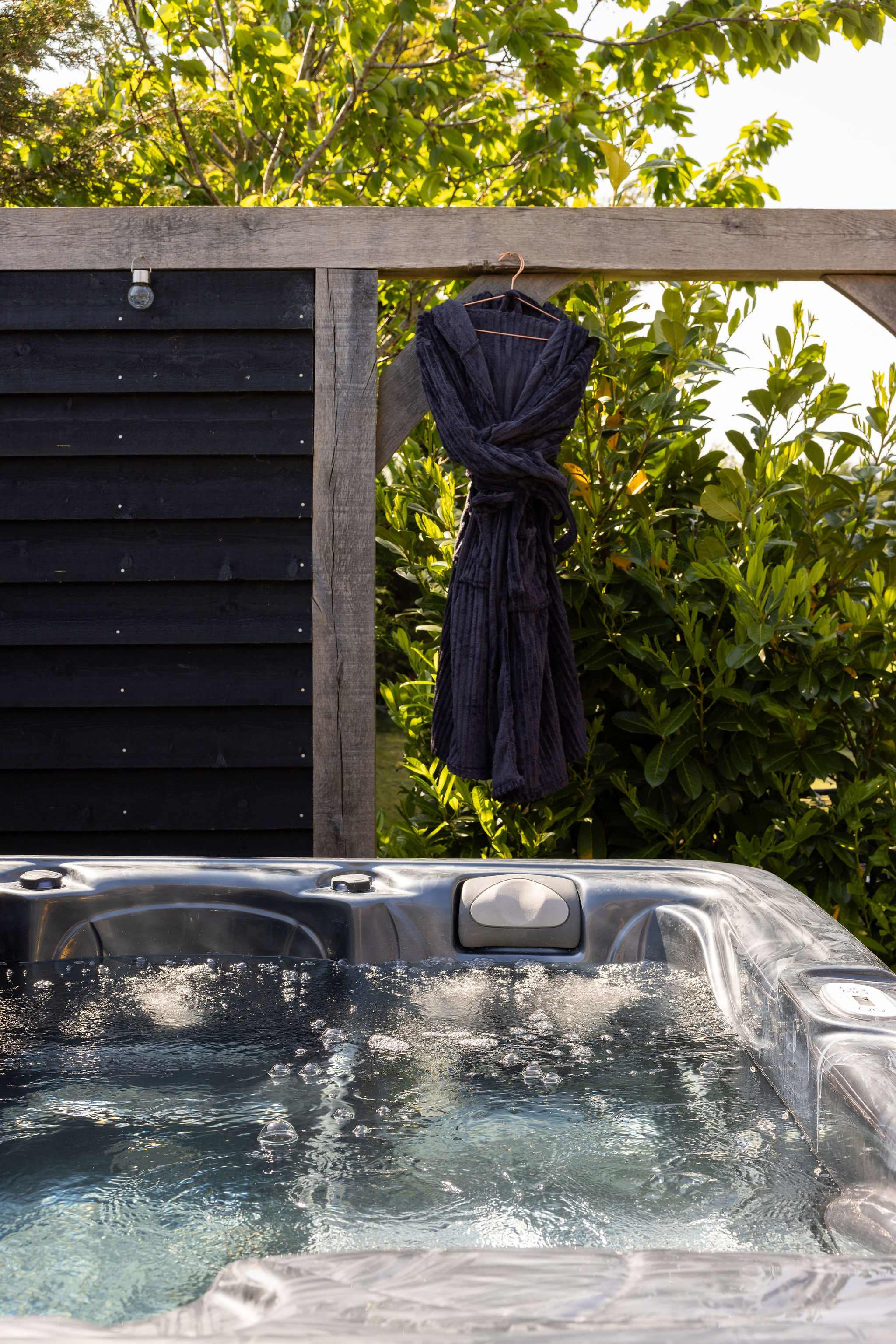 Enjoy total relaxation in the bubbling hot tub surrounded by tranquil countryside nature.