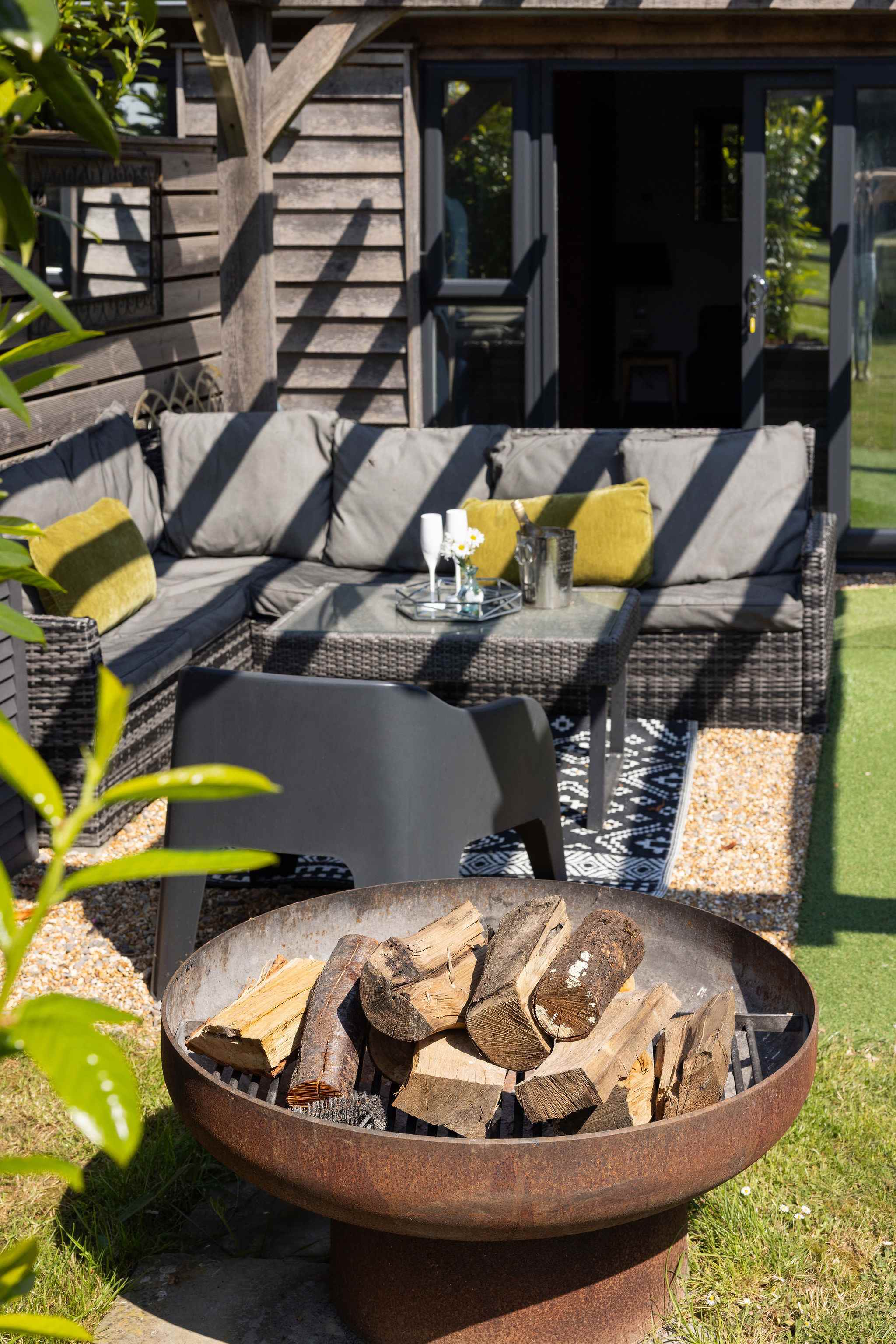 Gather around the fire pit for relaxing evenings in this comfortable outdoor lounge area.