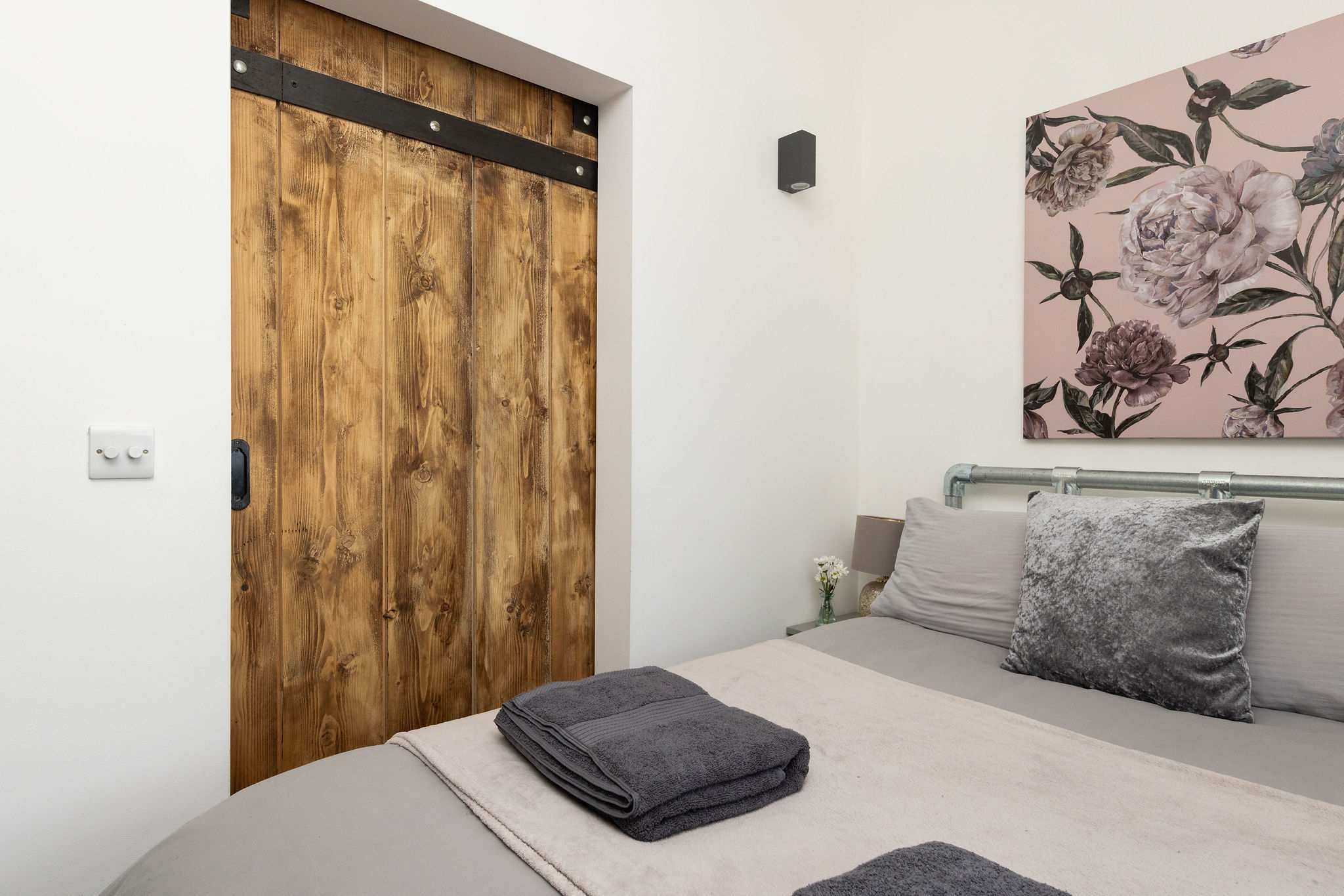 Tasteful furnishings and gorgeous wooden details create a wonderfully cozy bedroom retreat.
