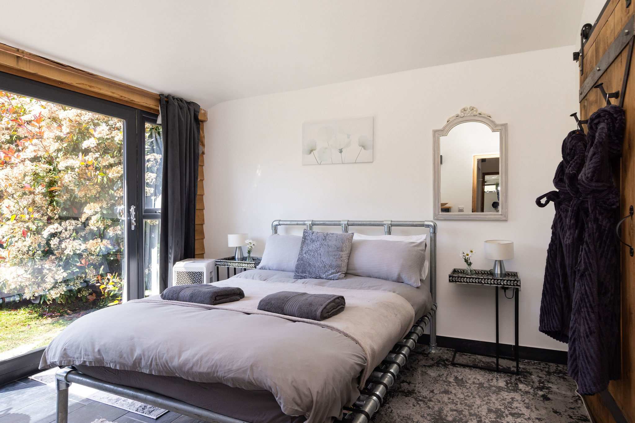 Rest easy in this stylish double bedroom featuring direct access to the beautiful outdoors.