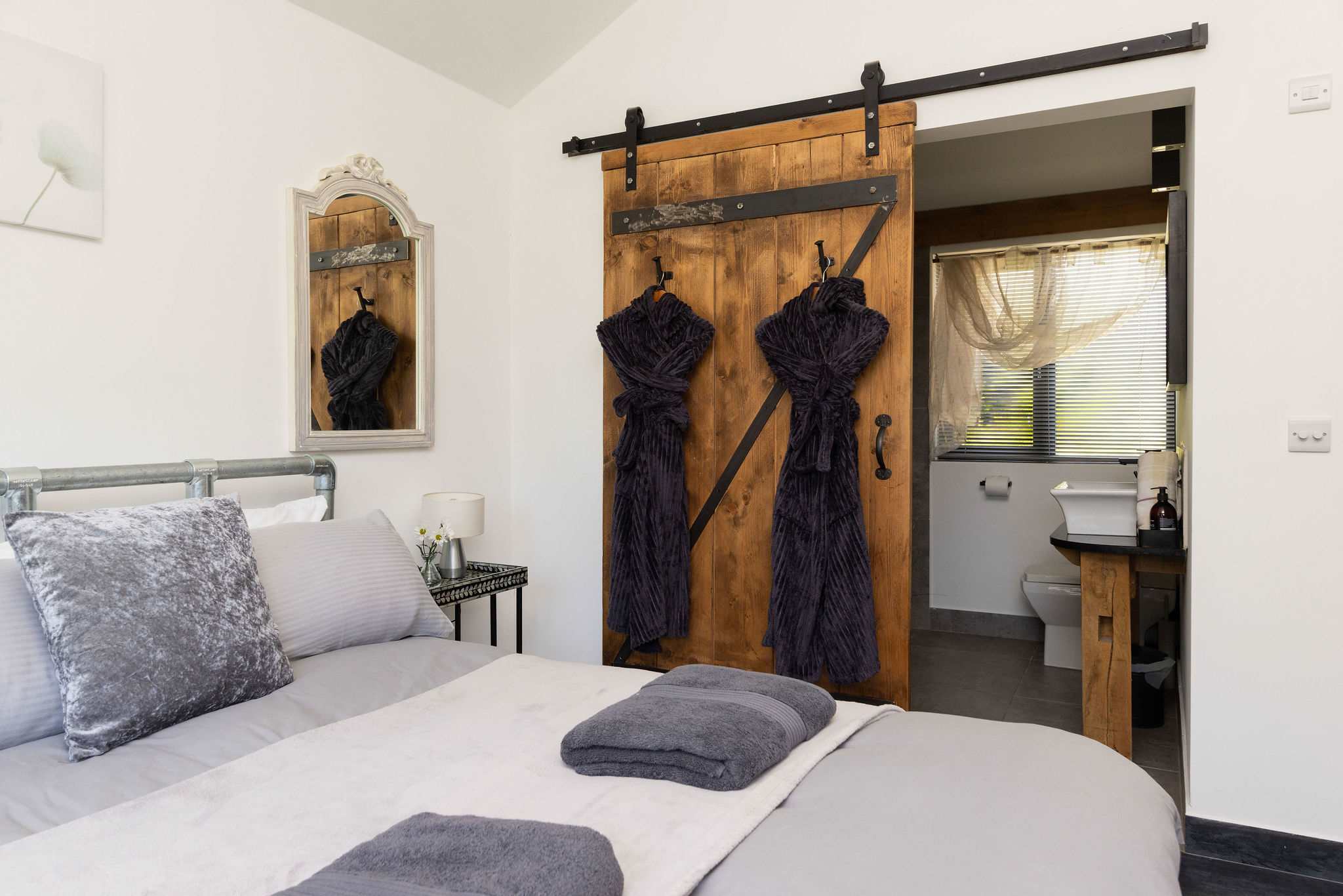 This peaceful sleeping space combines cozy rustic charm with the convenience of an ensuite.