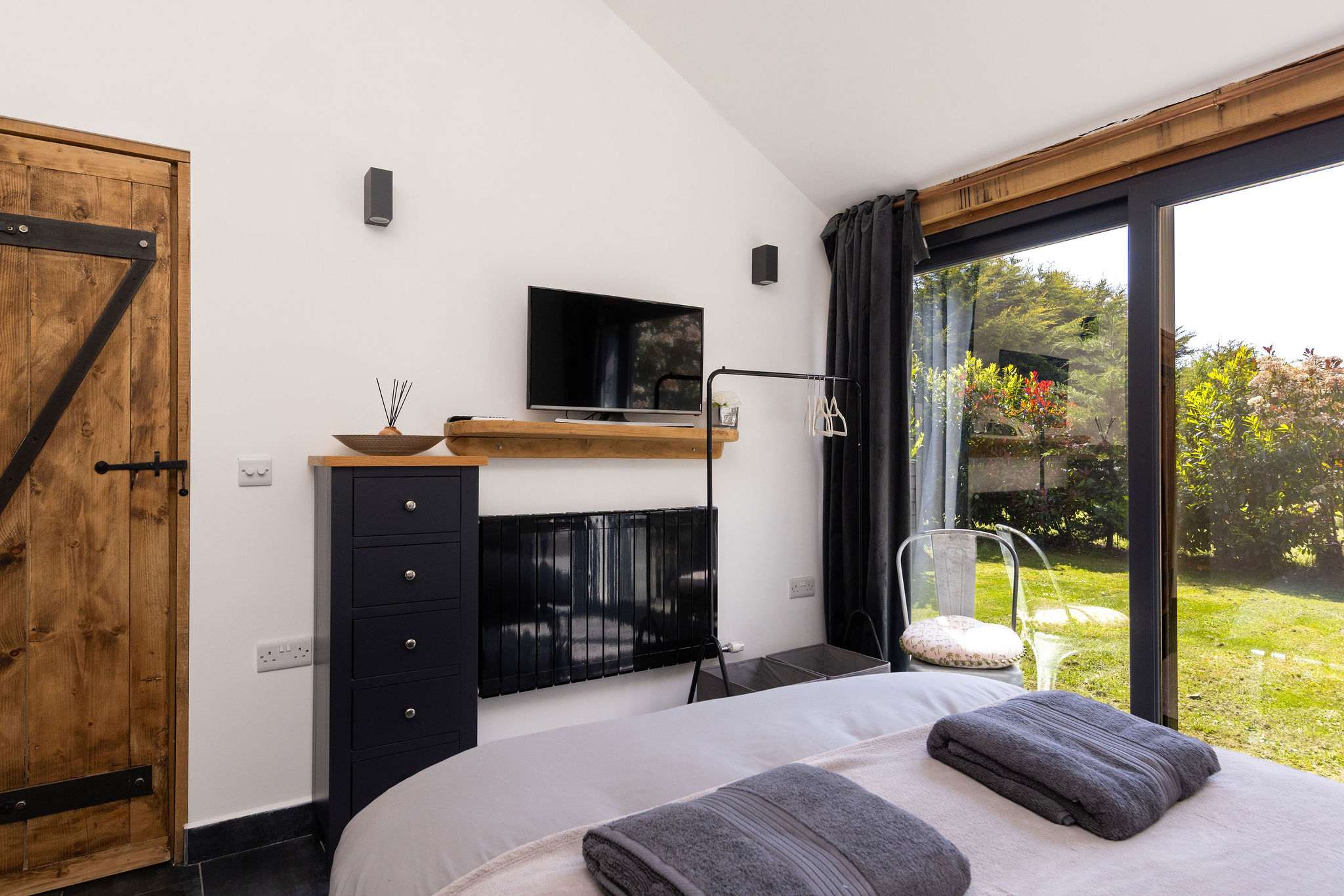 Enjoy bright mornings with floor-to-ceiling garden doors opening directly onto the spacious private courtyard.