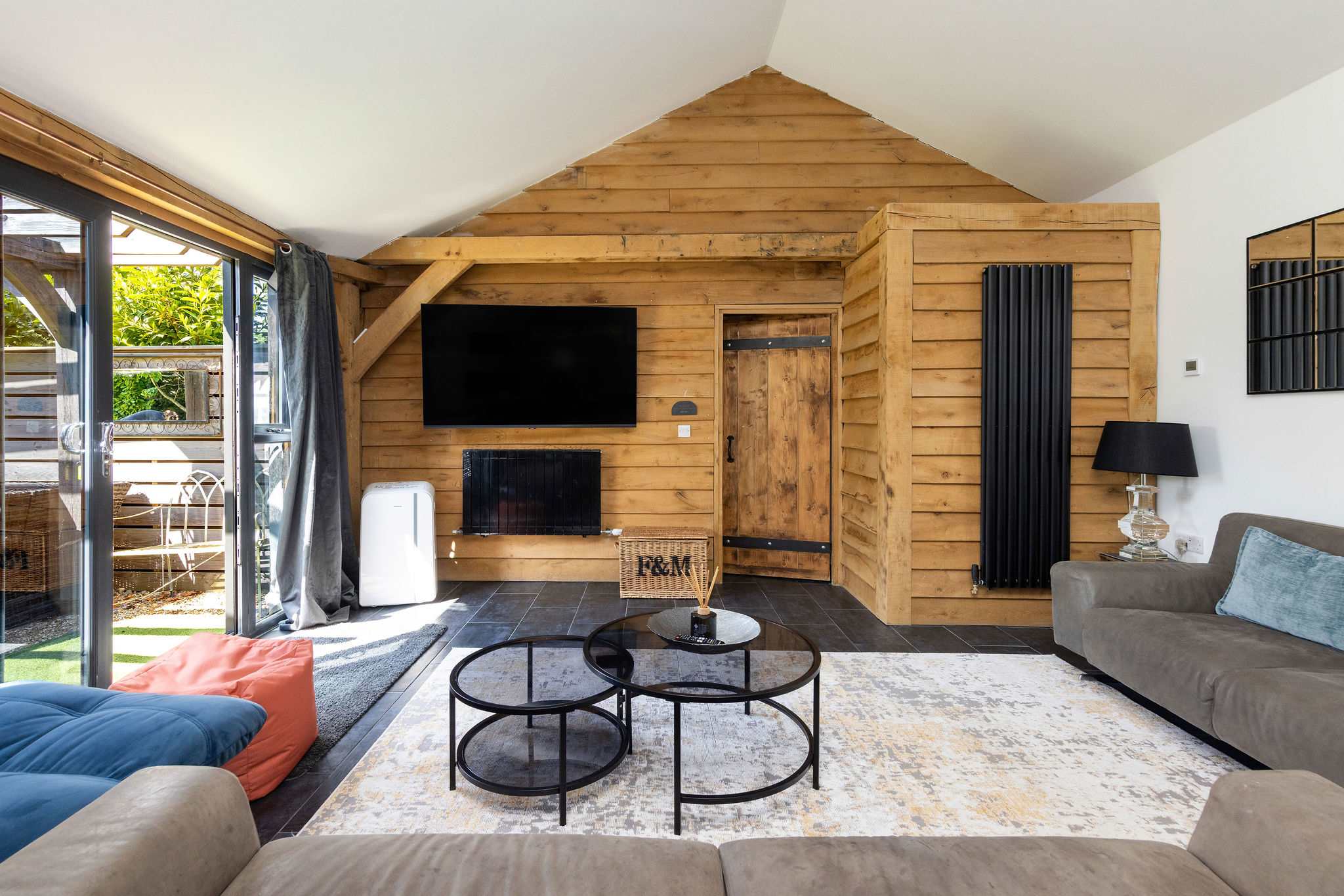 Cozy up in this stylish living area featuring rustic wood and courtyard access.