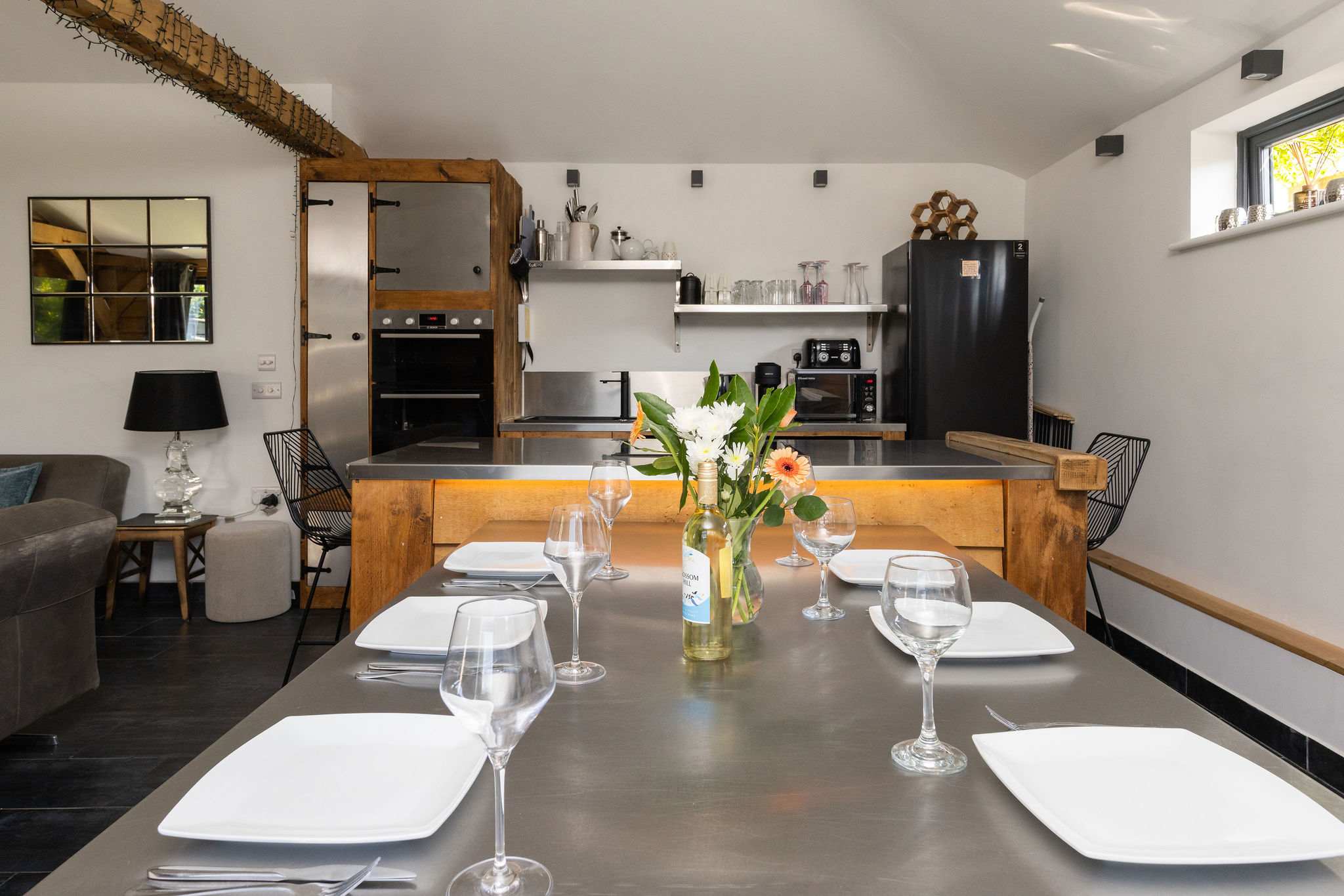 Gather around the substantial dining table, perfectly designed for memorable family meals and entertaining.