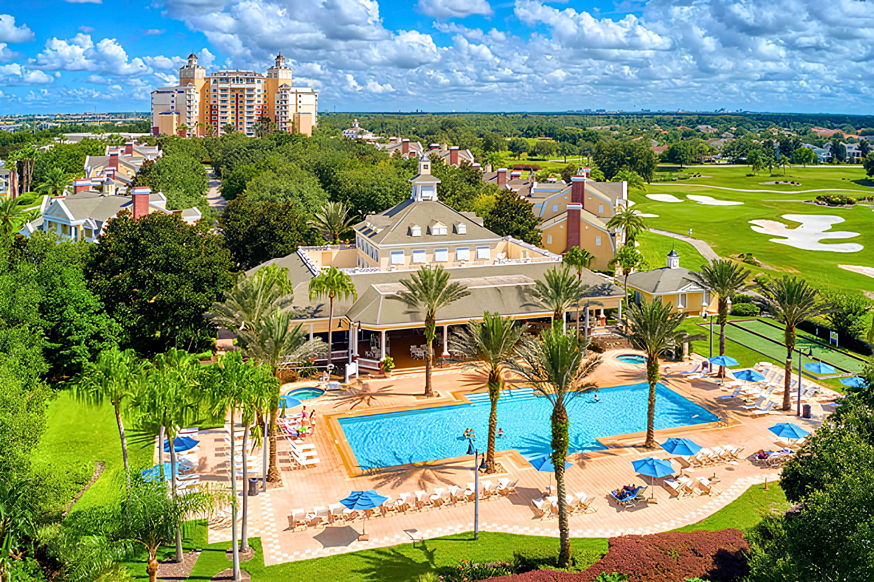 Seven Eagles clubhouse and pool with hot tubs, lounge seating, and a poolside tiki bar perfect for relaxing after the parks