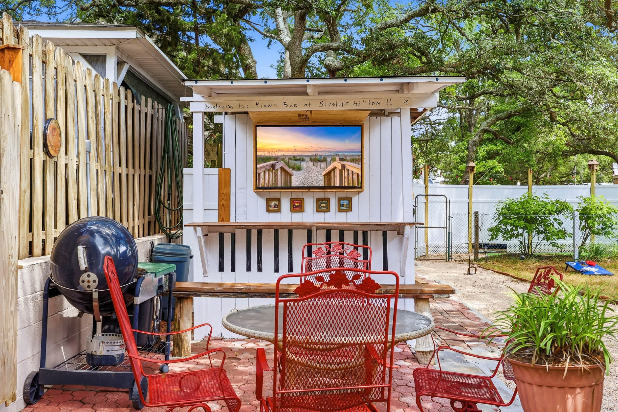 Outdoor bar with TV, seating and grill