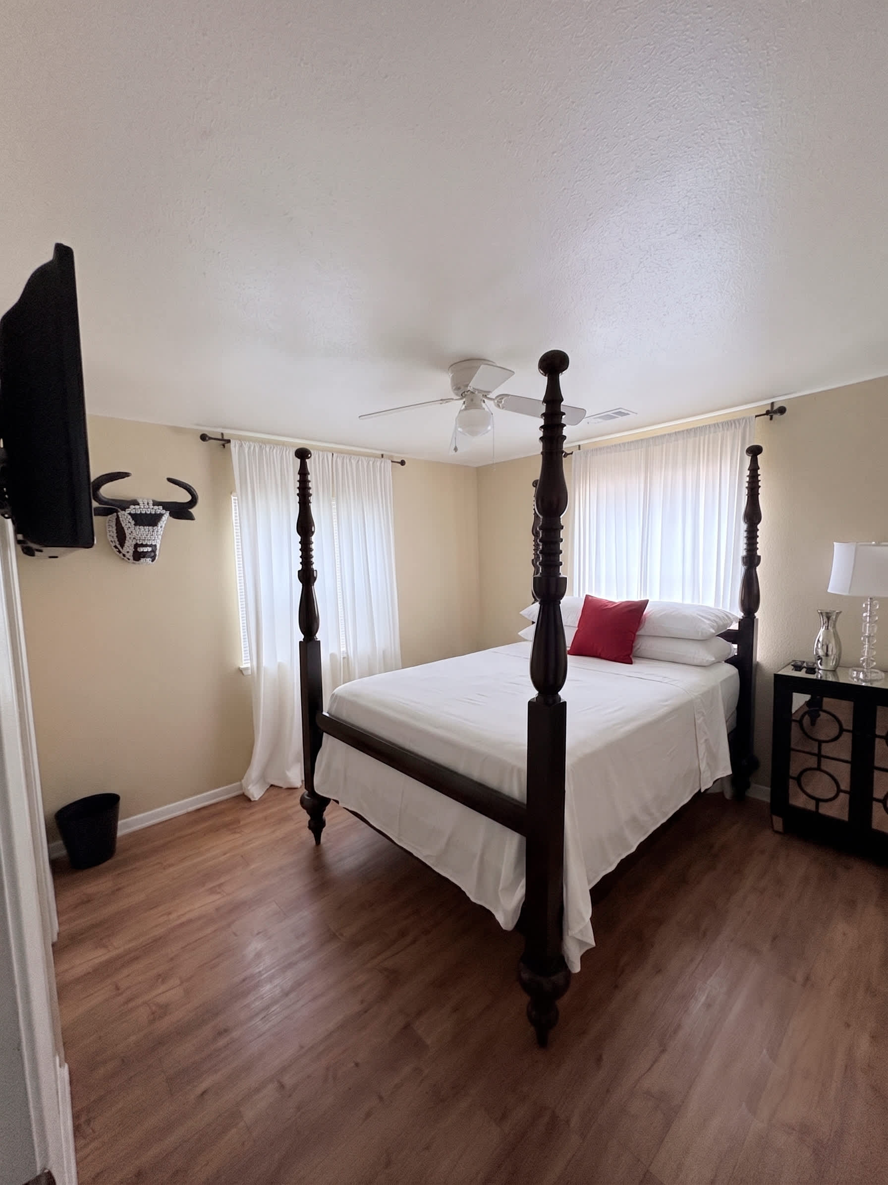 Unwind in the elegant master bedroom featuring a classic four-poster bed.