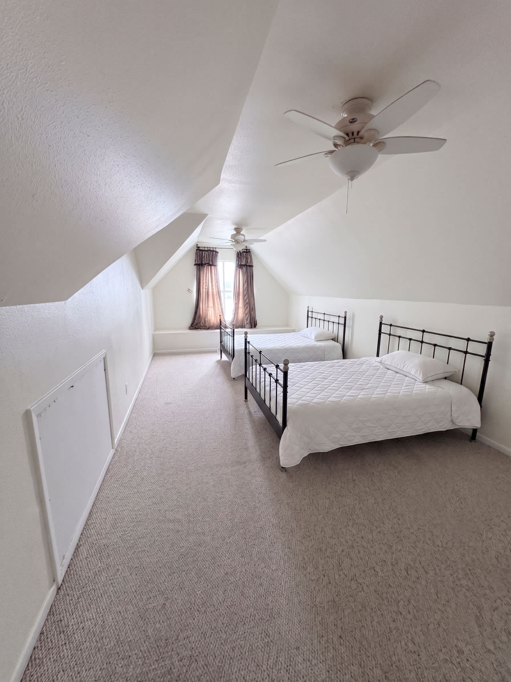 Relax in the spacious, light-filled loft bedroom with comfortable bedding.