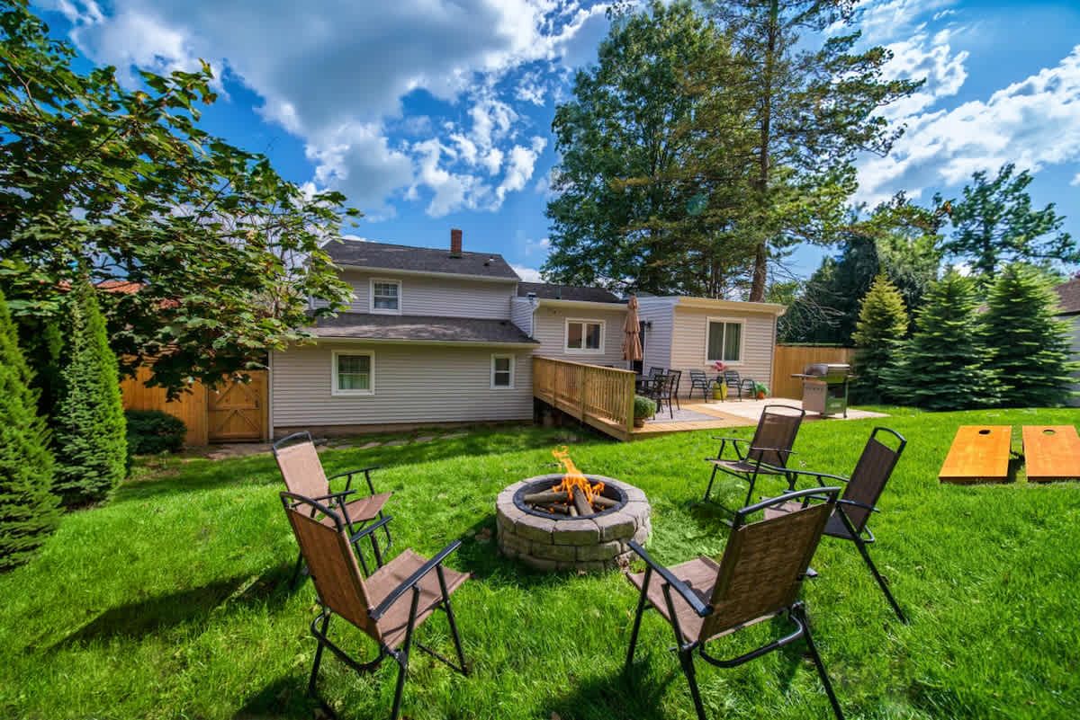 Relax Outdoors in the private fenced yard with firepit and cornhole }}