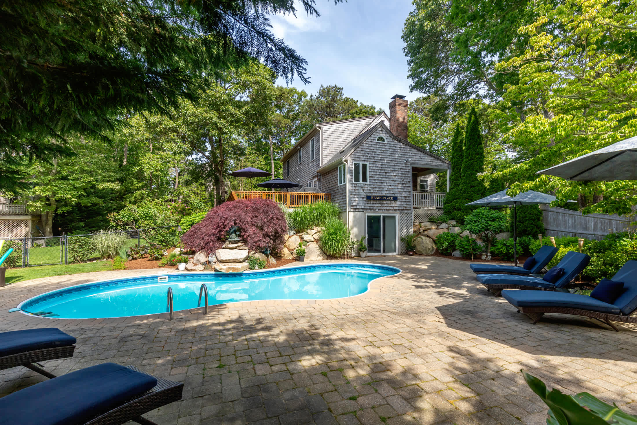 Beautiful Eastham home featuring lush gardens with heated in ground pool
