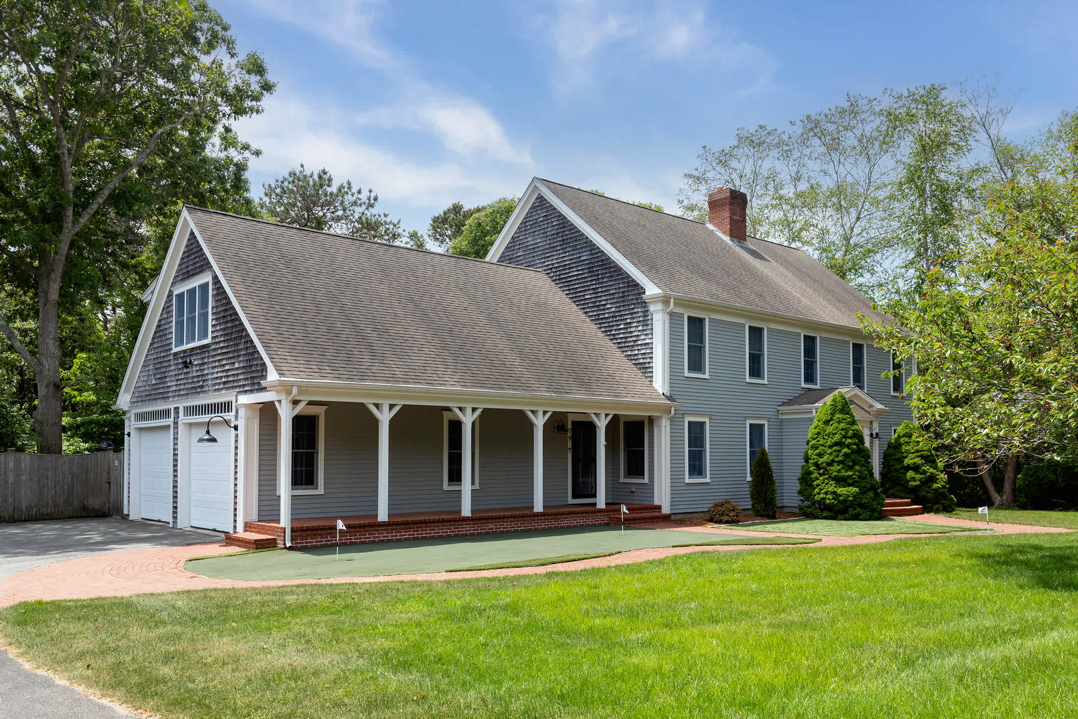 Sprawling Yarmouth Port Cape Cod vacation rental with broad lawn and private drive, peaceful estate setting near Mayflower Beach.