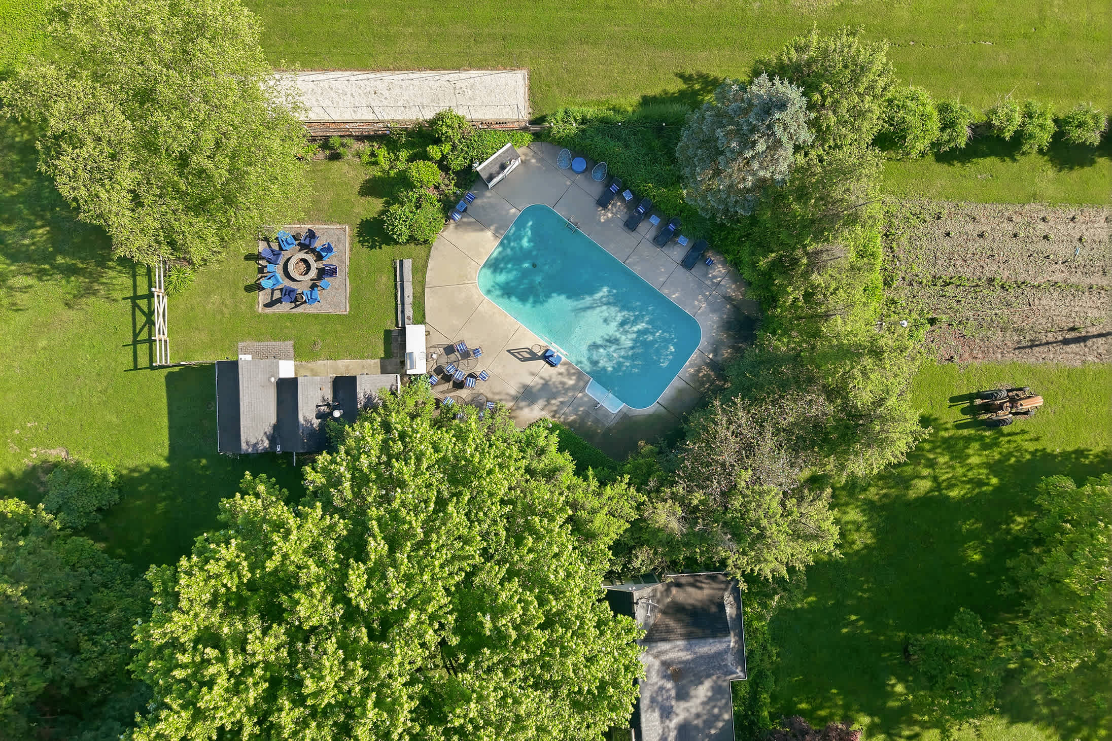 The full outdoor retreat, framed by lush, private grounds.