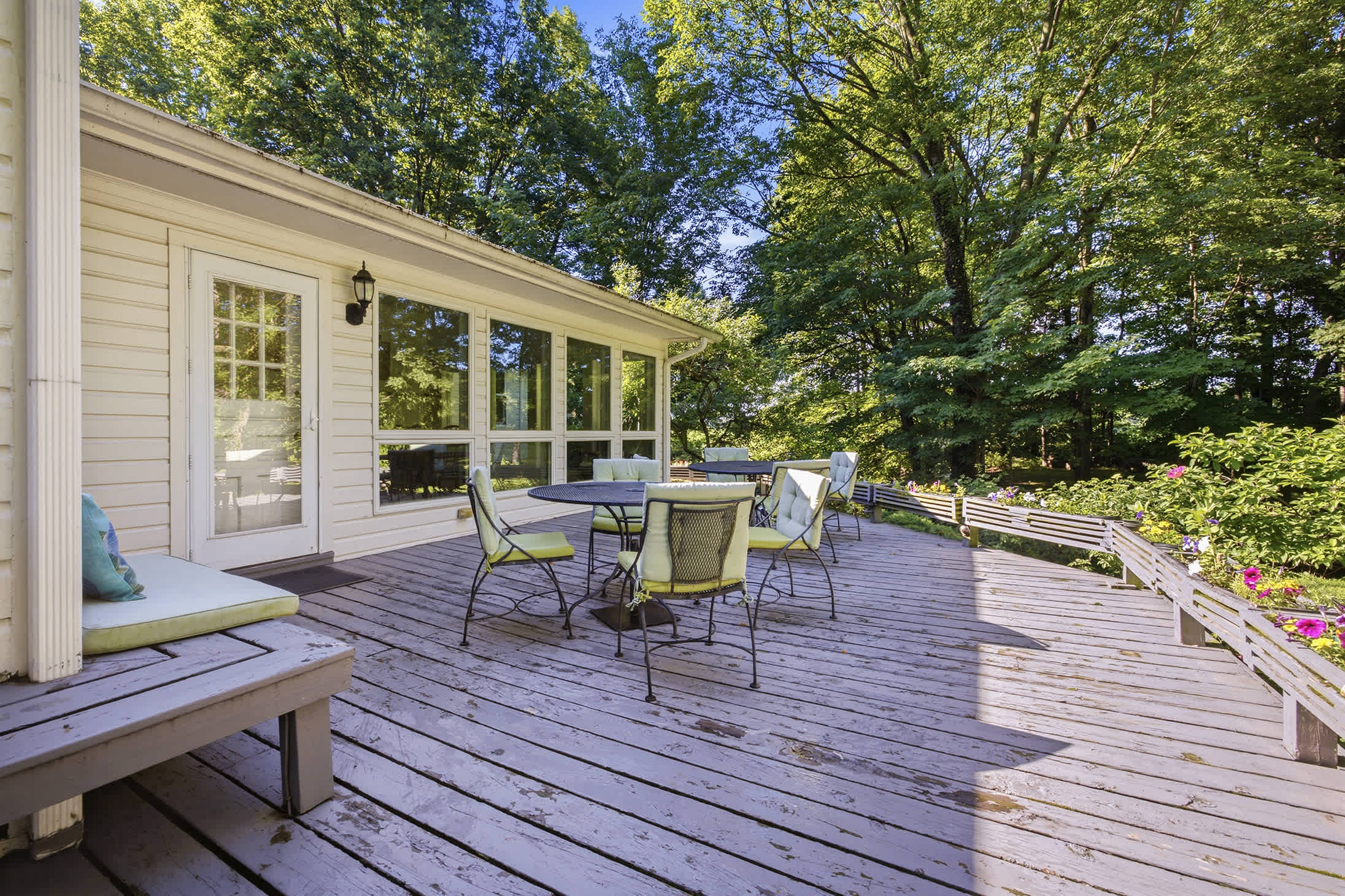 Dine outdoors at The Farmhouse with beautiful wooded scenery.