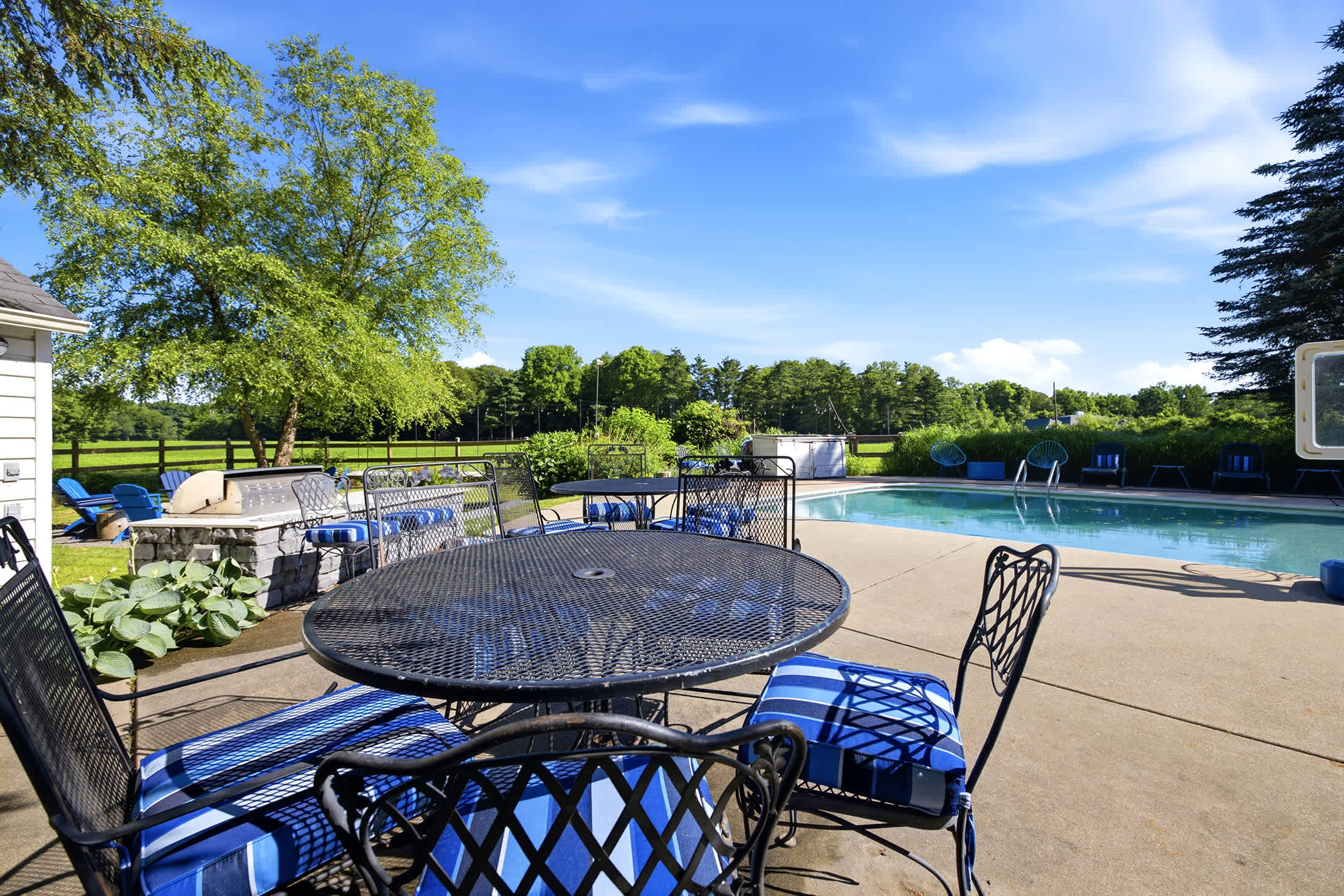 Poolside dining and lounging with open country views.