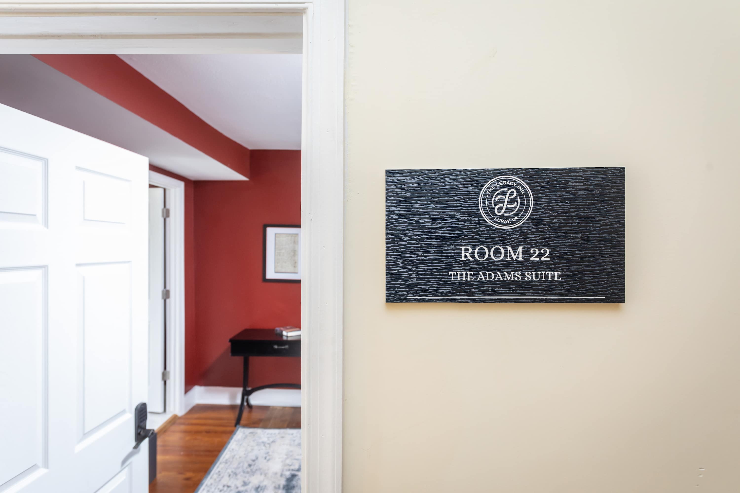 Entrance to room 22, the Adams suite, featuring a warm red interior and classic decor.