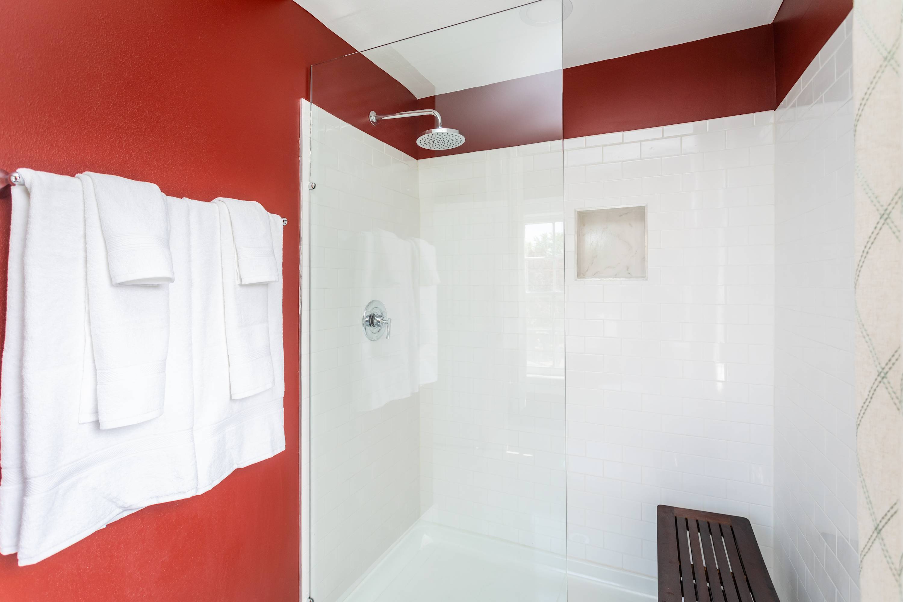 Modern shower area with white subway tiles and a rainfall showerhead.
