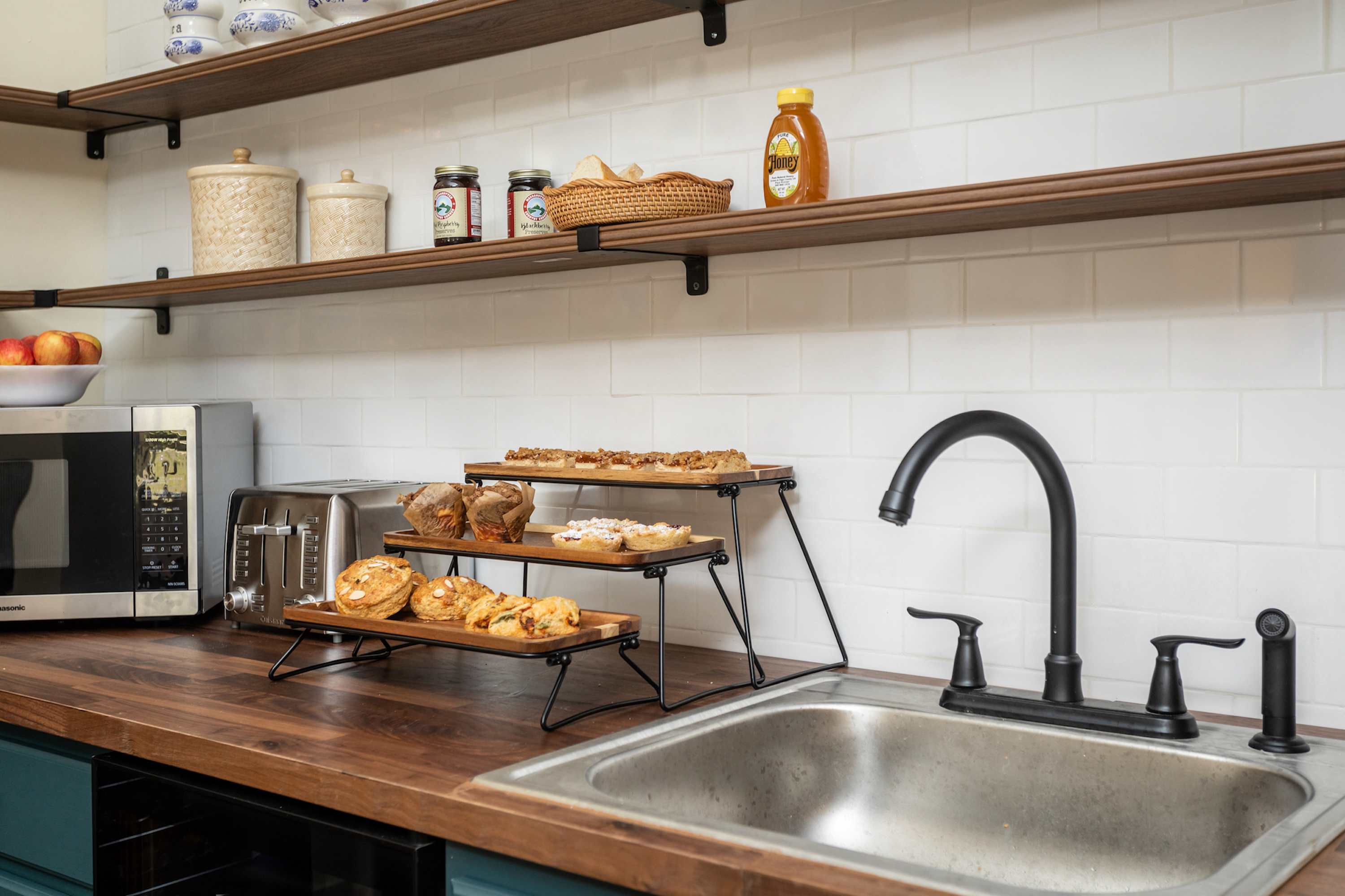 Modern kitchen countertop with a black faucet and a variety of baked goods on display