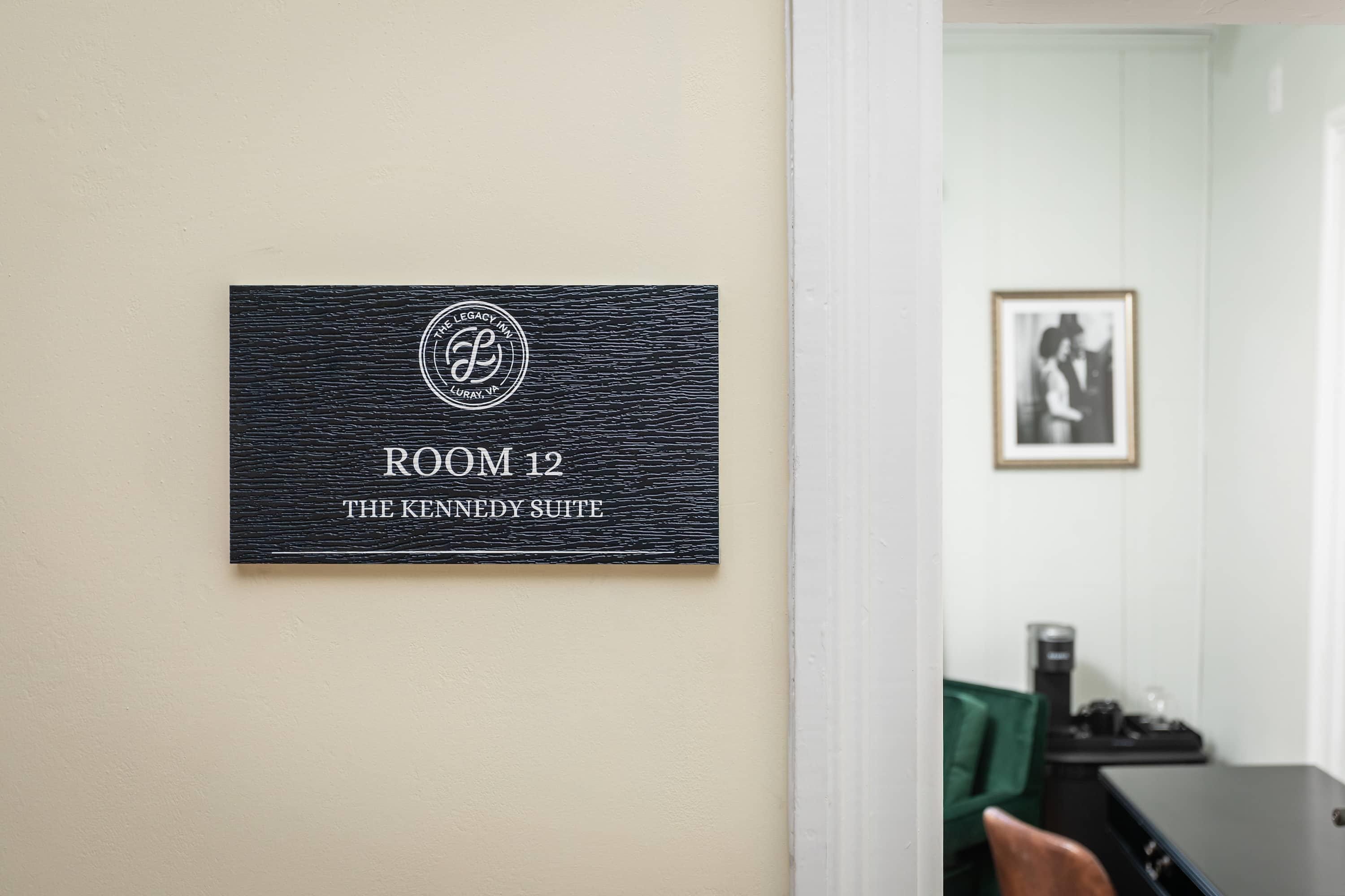 Entrance to the kennedy suite at the legacy inn with a glimpse of the room's interior.