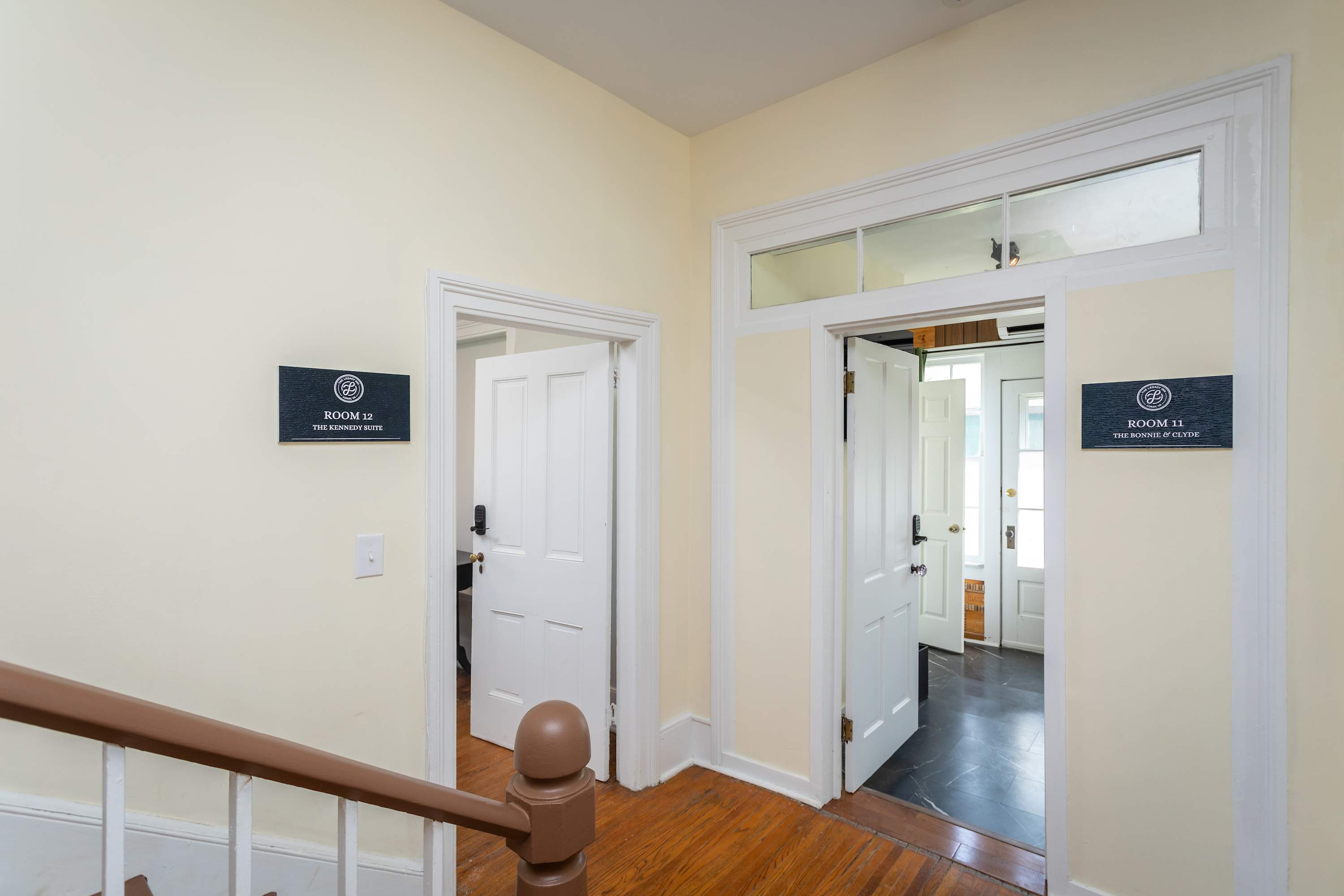 Entrance to rooms 11 and 12 with classic white doors and hardwood floors.