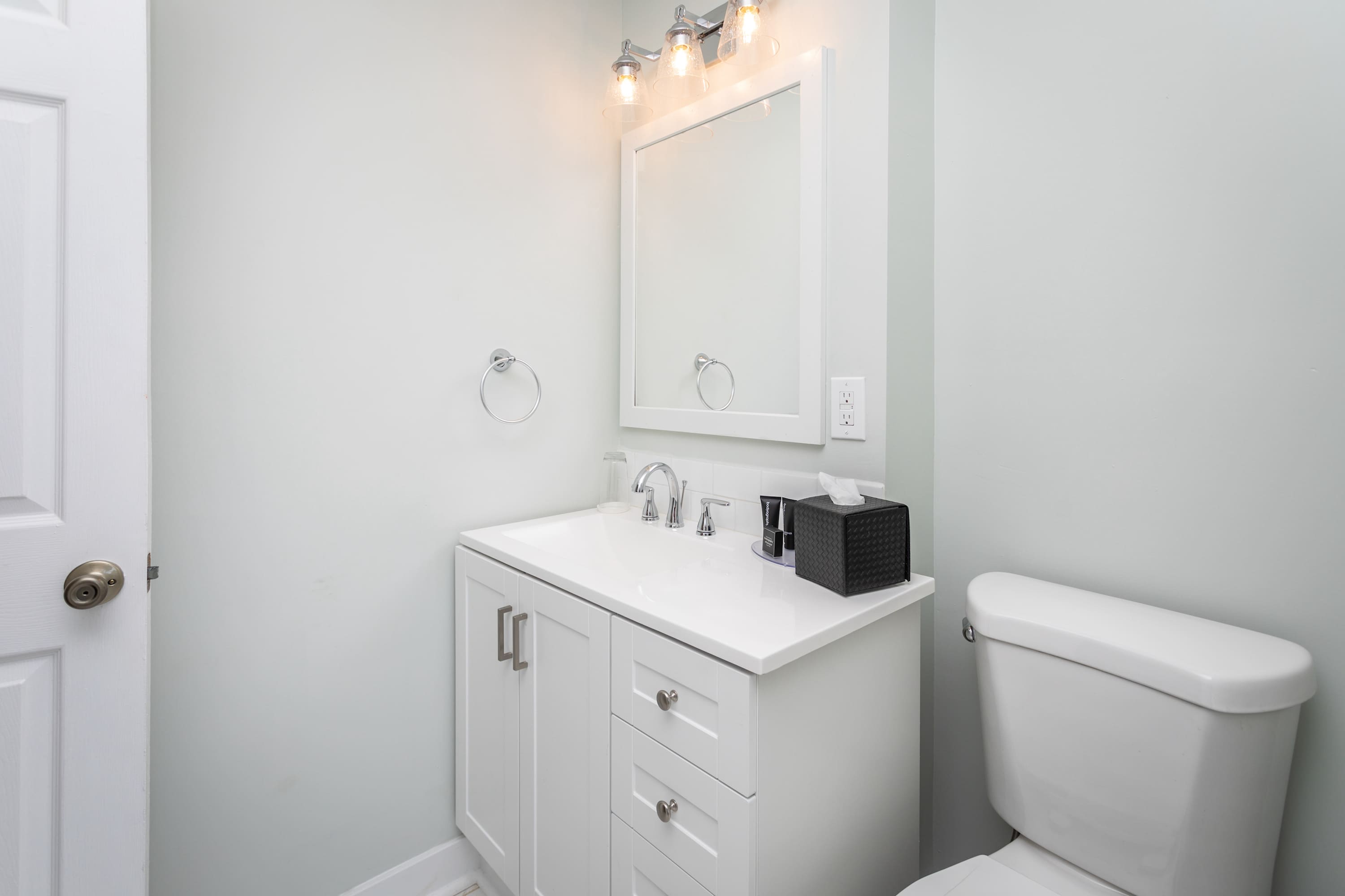 Modern bathroom with white vanity and bright lighting