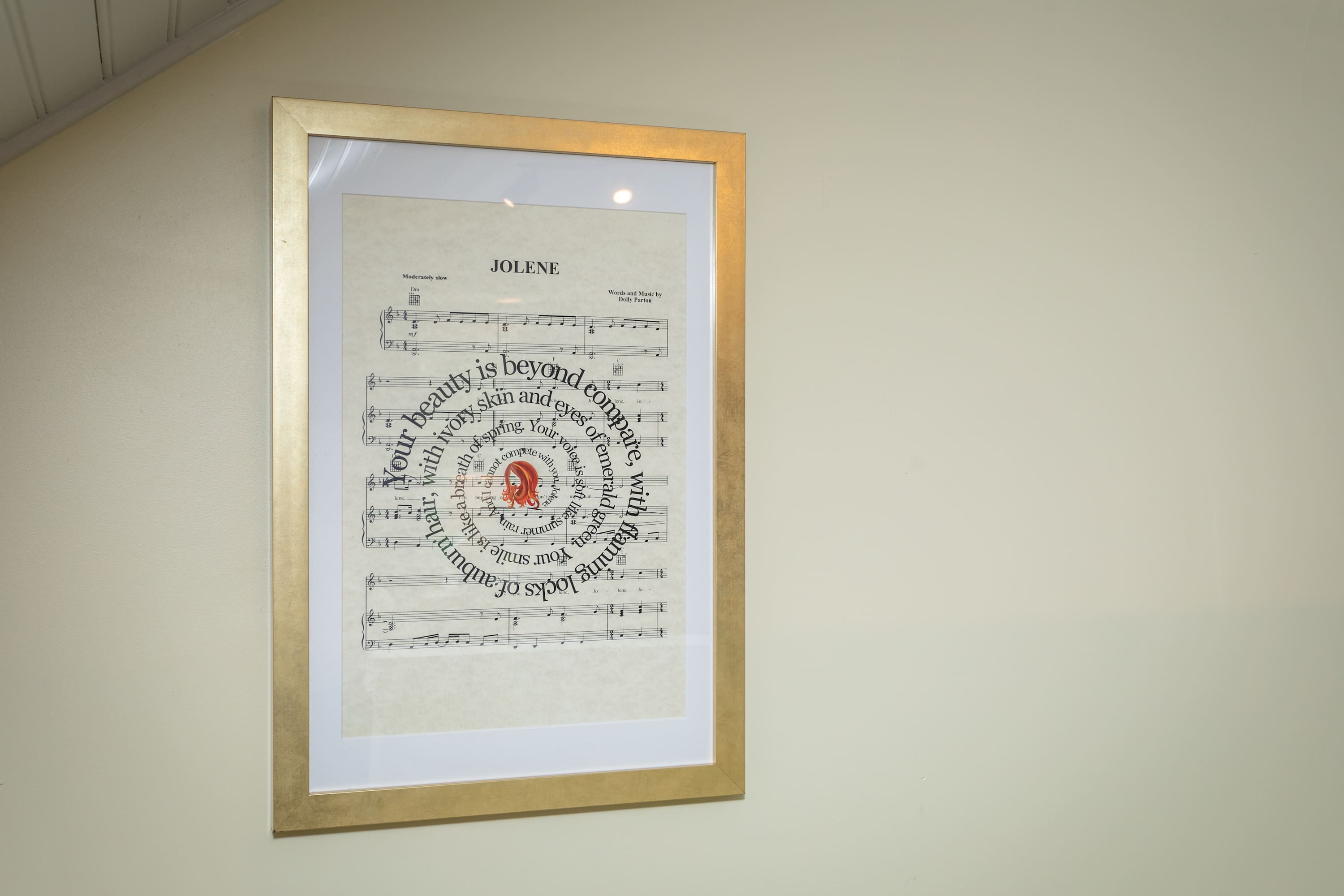 Framed sheet music art with a gold frame adds a musical touch to the room.